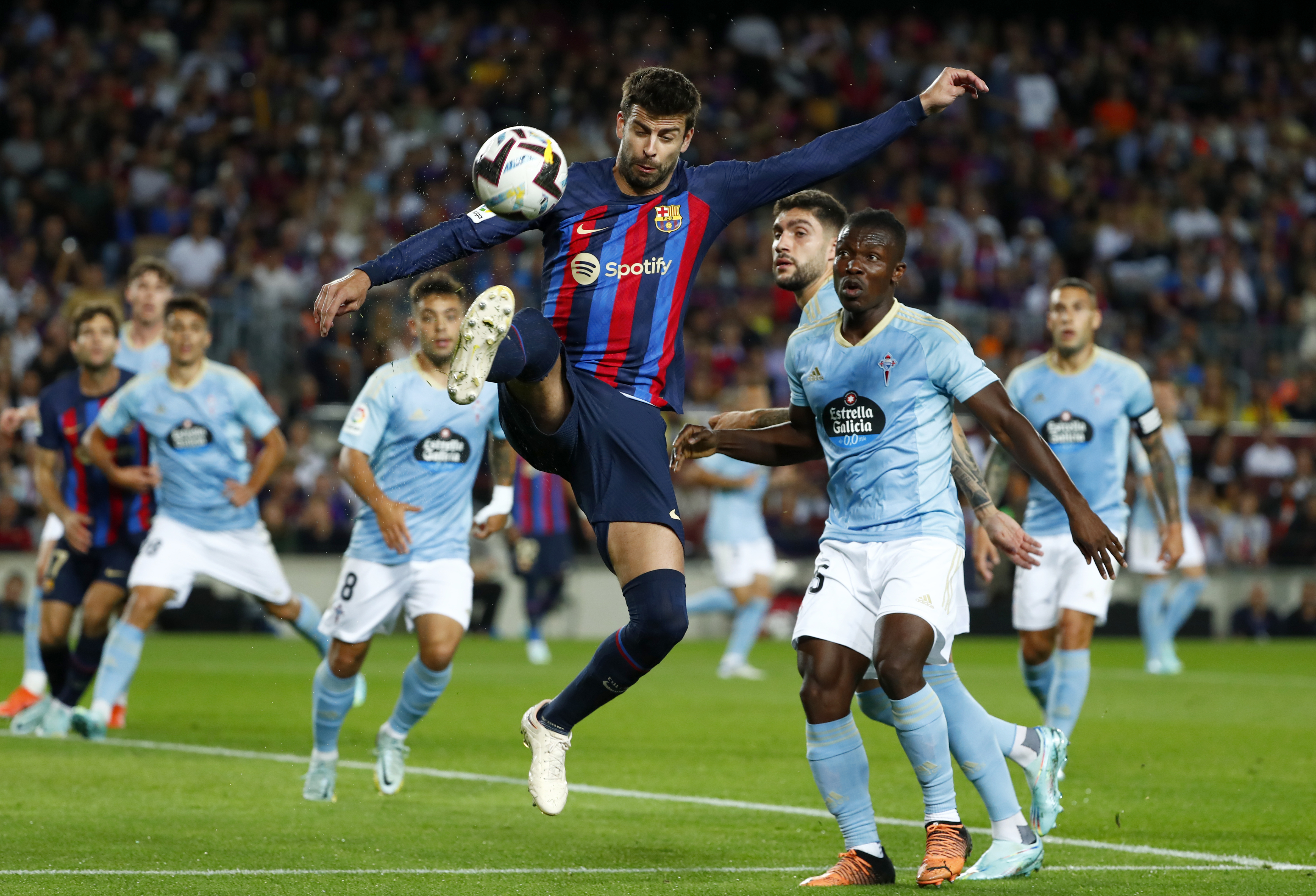 Barcelona's Gerard Pique kicks the ball during a Spanish La Liga soccer match between FC Barcelona and Celta Vigo at Camp Nou stadium in Barcelona, Spain, Sunday, Oct. 9, 2022. (AP Photo/Joan Monfort)