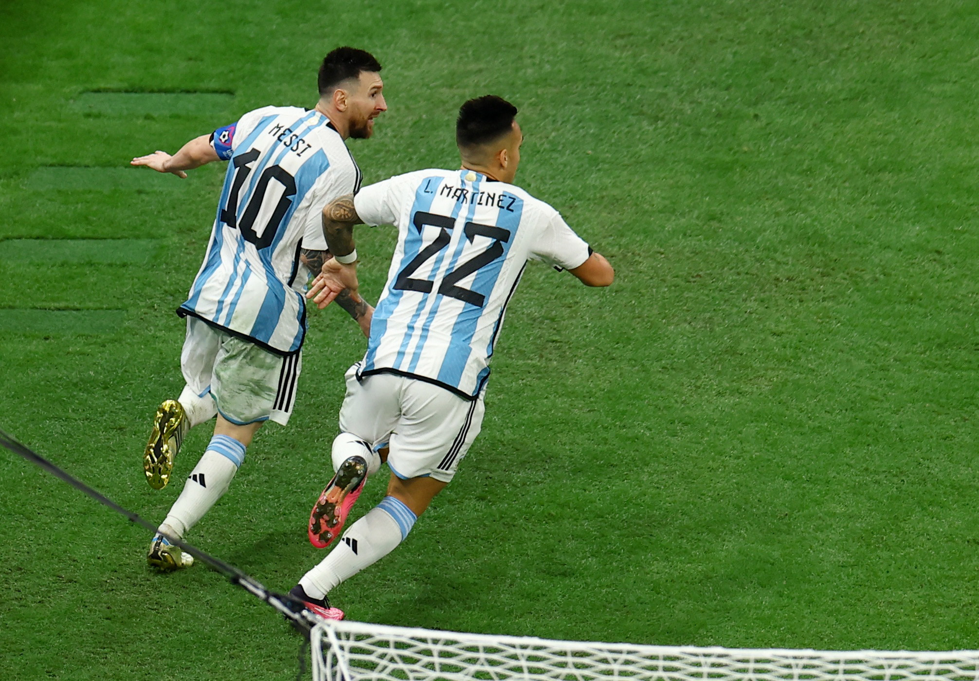 Soccer Football - FIFA World Cup Qatar 2022 - Final - Argentina v France - Lusail Stadium, Lusail, Qatar - December 18, 2022 Argentina's Lionel Messi celebrates scoring their third goal with teammate Lautaro Martinez REUTERS/Molly Darlington