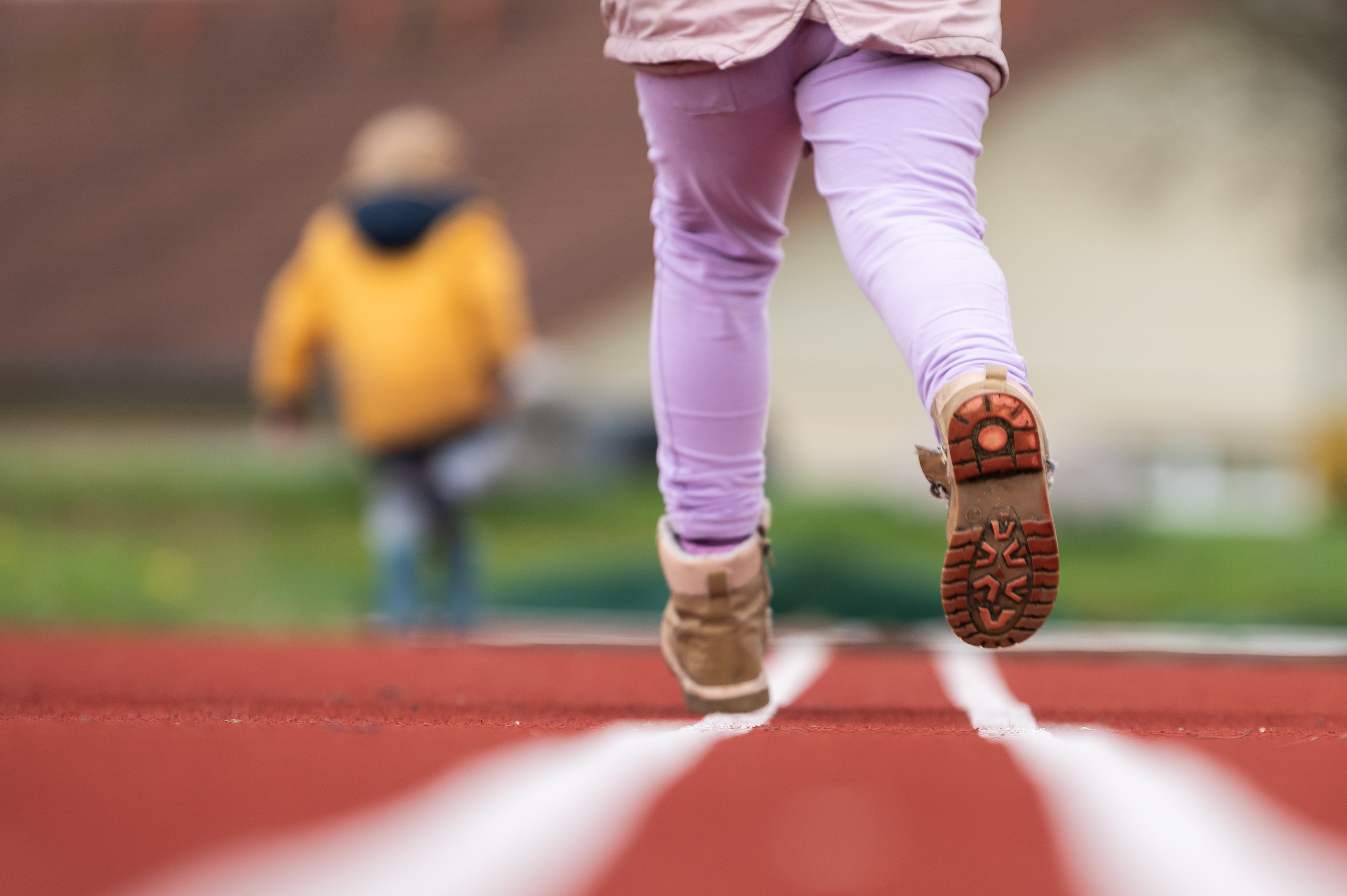 SYMBOL - 19 April 2023, Baden-Württemberg, Rottweil: Children running on a tartan track. Photo: Silas Stein/dpa (Photo by Silas Stein/picture alliance via Getty Images)