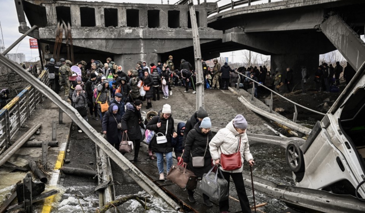 Los adultos mayores, con bastón en mano, deben cruzar difíciles obstáculos y largas distancias para salir de las ciudades atacadas en Rusia.