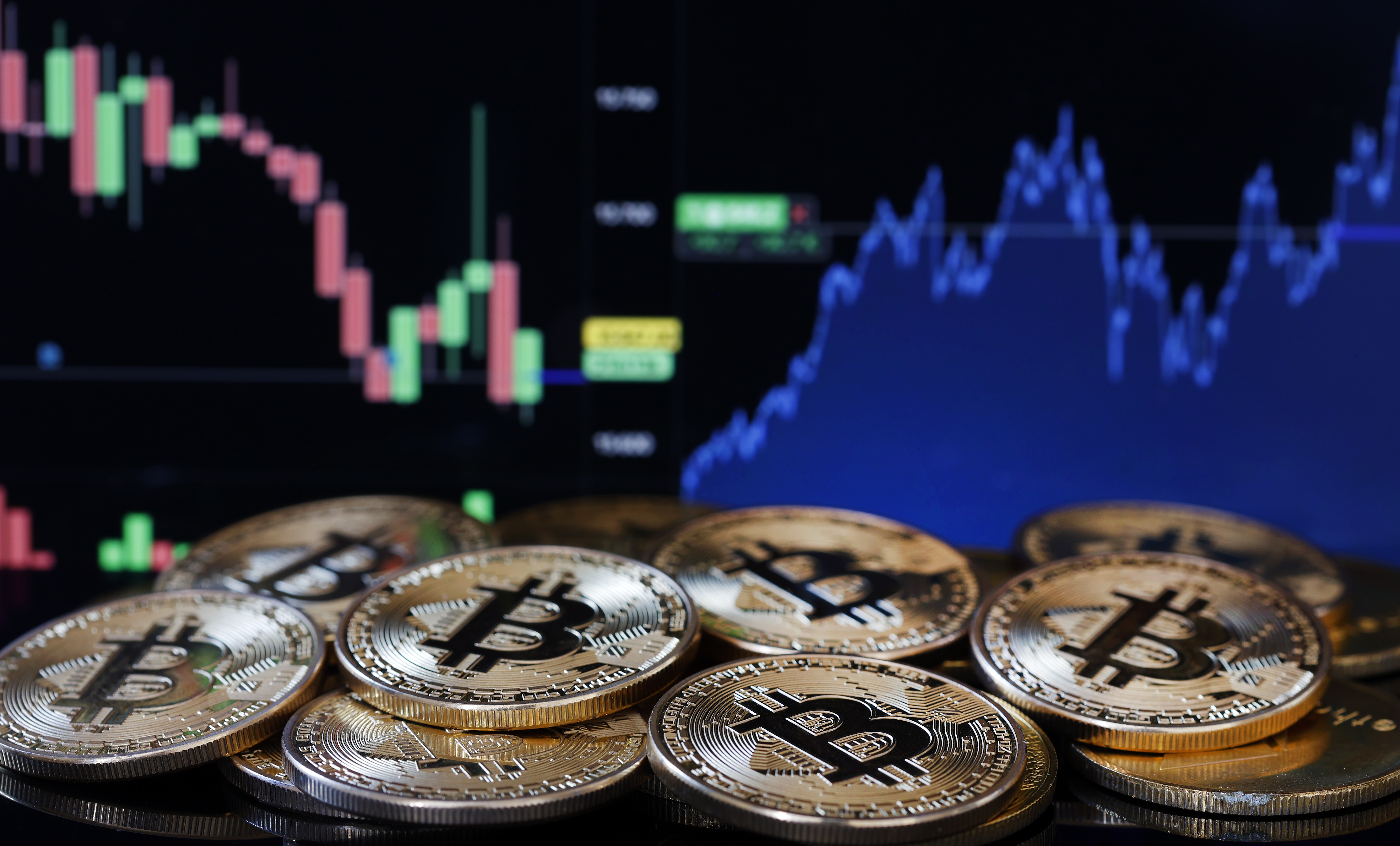 PARIS, FRANCE - JANUARY 11:  In this photo illustration, a visual representation of the digital cryptocurrency Bitcoin is displayed in front of a Bitcoin course's graph on January 11, 2024 in Paris, France. The first American Bitcoin ETF was authorized by the SEC (Commissioner of the American Stock Exchange) on Wednesday January 10, 2024. Around ten of the world's largest financial asset managers have filed an application with the SEC to launch a Bitcoin. ETFs. After blocking bitcoin from entering Wall Street for more than 10 years, the Securities and Exchange Commission (SEC) has given the green light to exchange-traded funds (ETFs) invested in bitcoin. (Photo illustration by Chesnot/Getty Images)