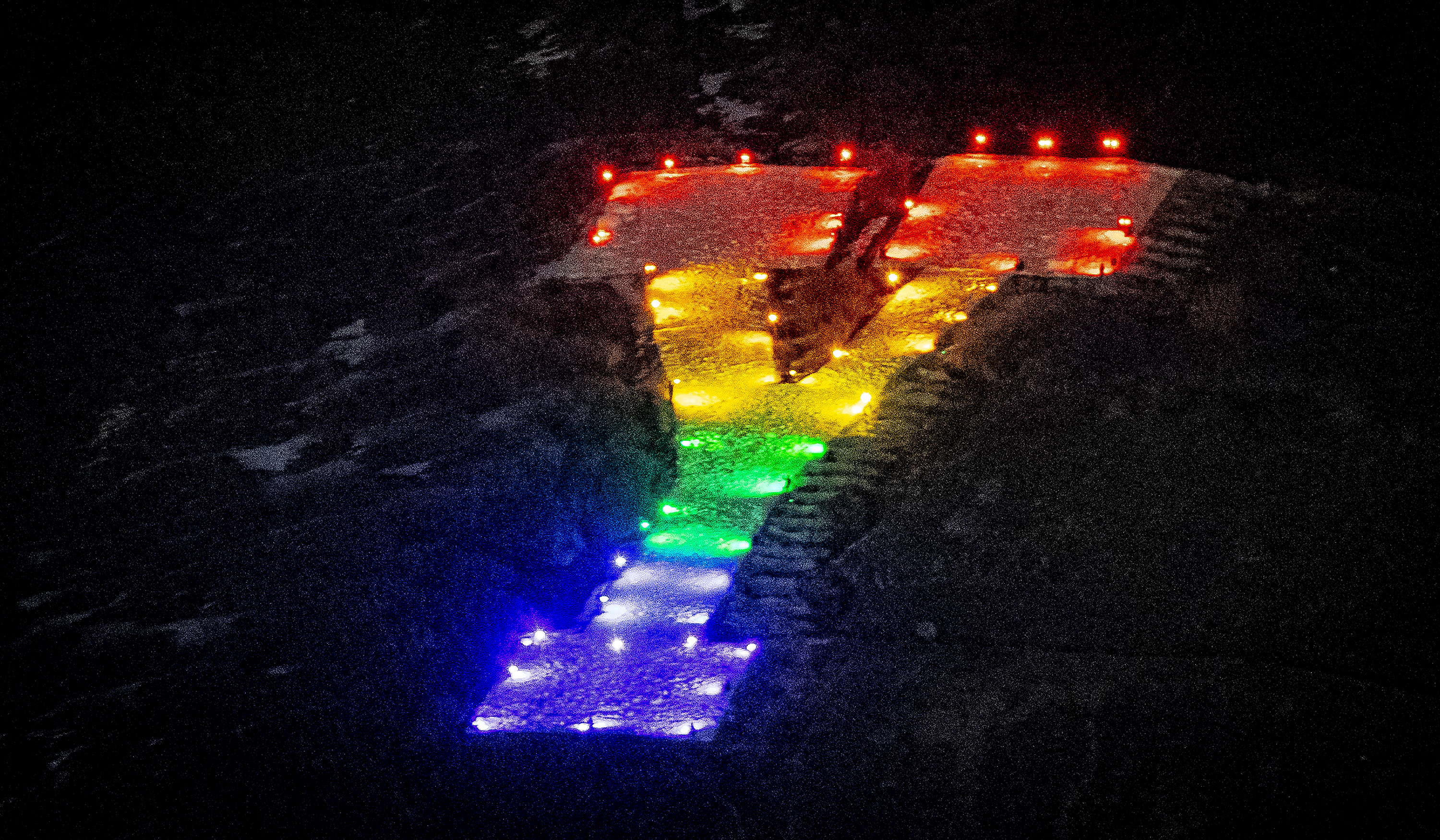students at BYU light up the 'Y' in rainbow colors