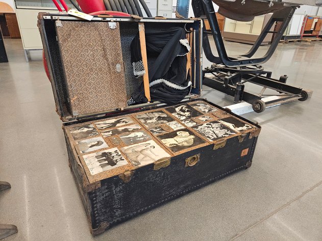 This trunk has everything — old-timey photos, hidden compartments and an outfit. 
