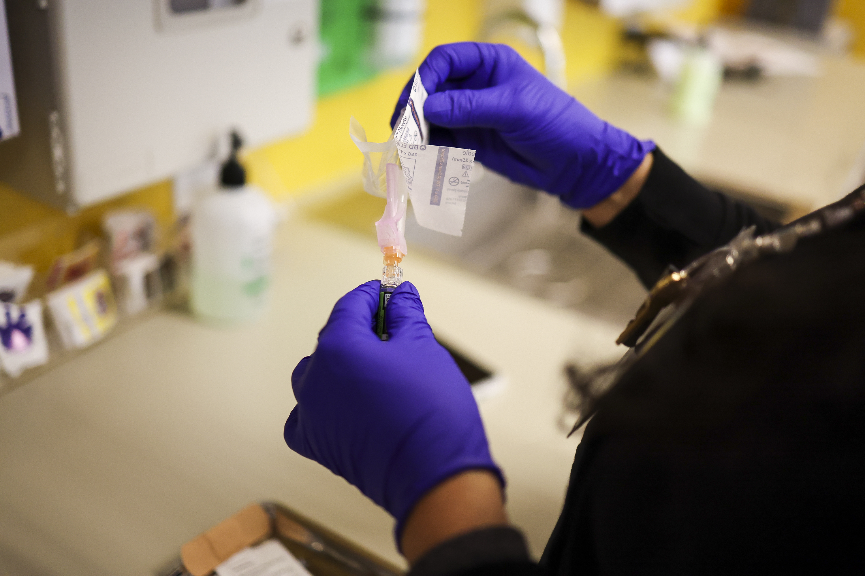 Medical assistant Loreal Velastegui prepares a flu vaccine to be administered at the Esperanza Health Centers Brighton Park North Clinic on Dec. 31, 2025.