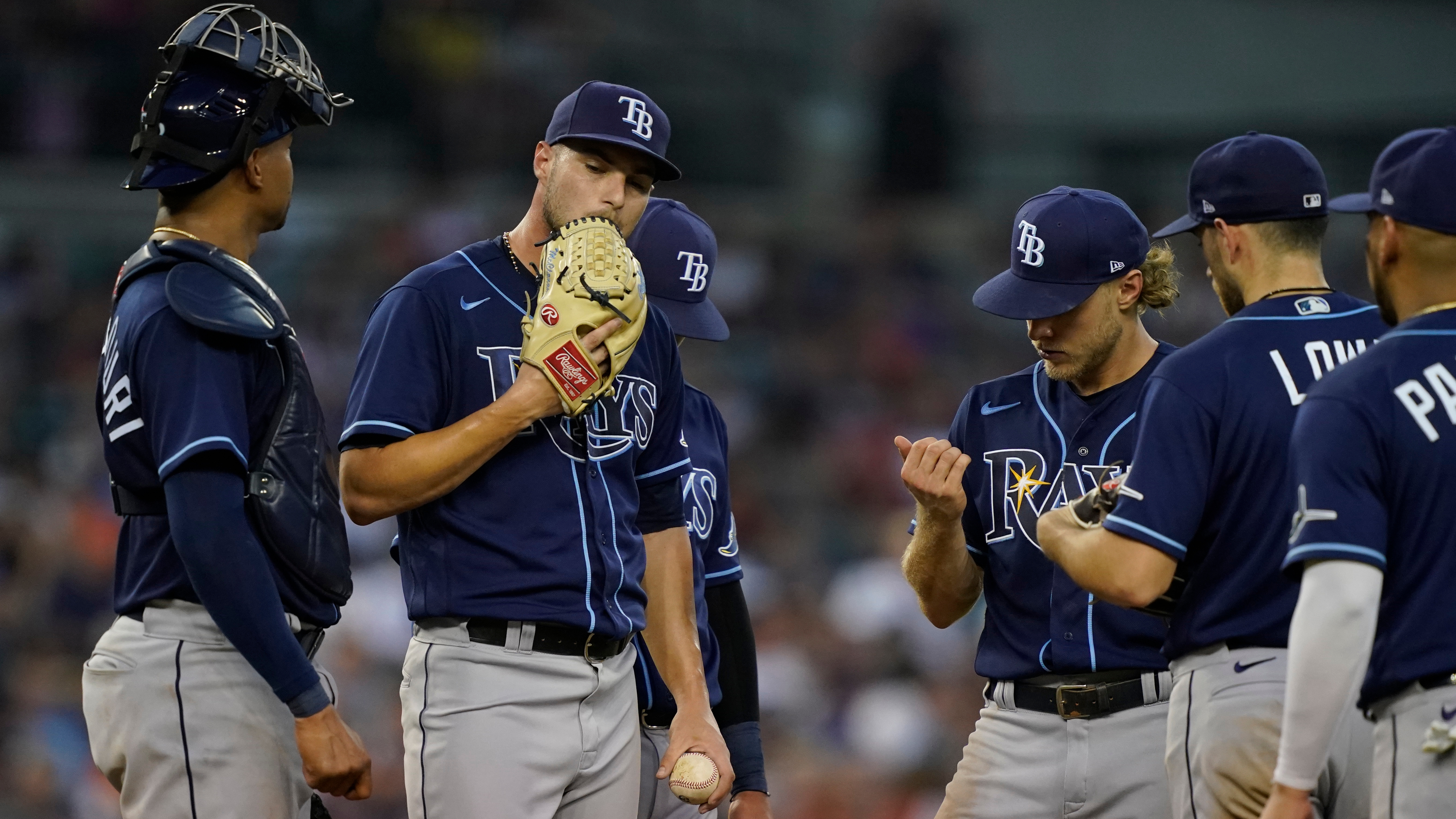 Tampa Bay Rays pitching coach Kyle Snyder, left, looks on as Shane