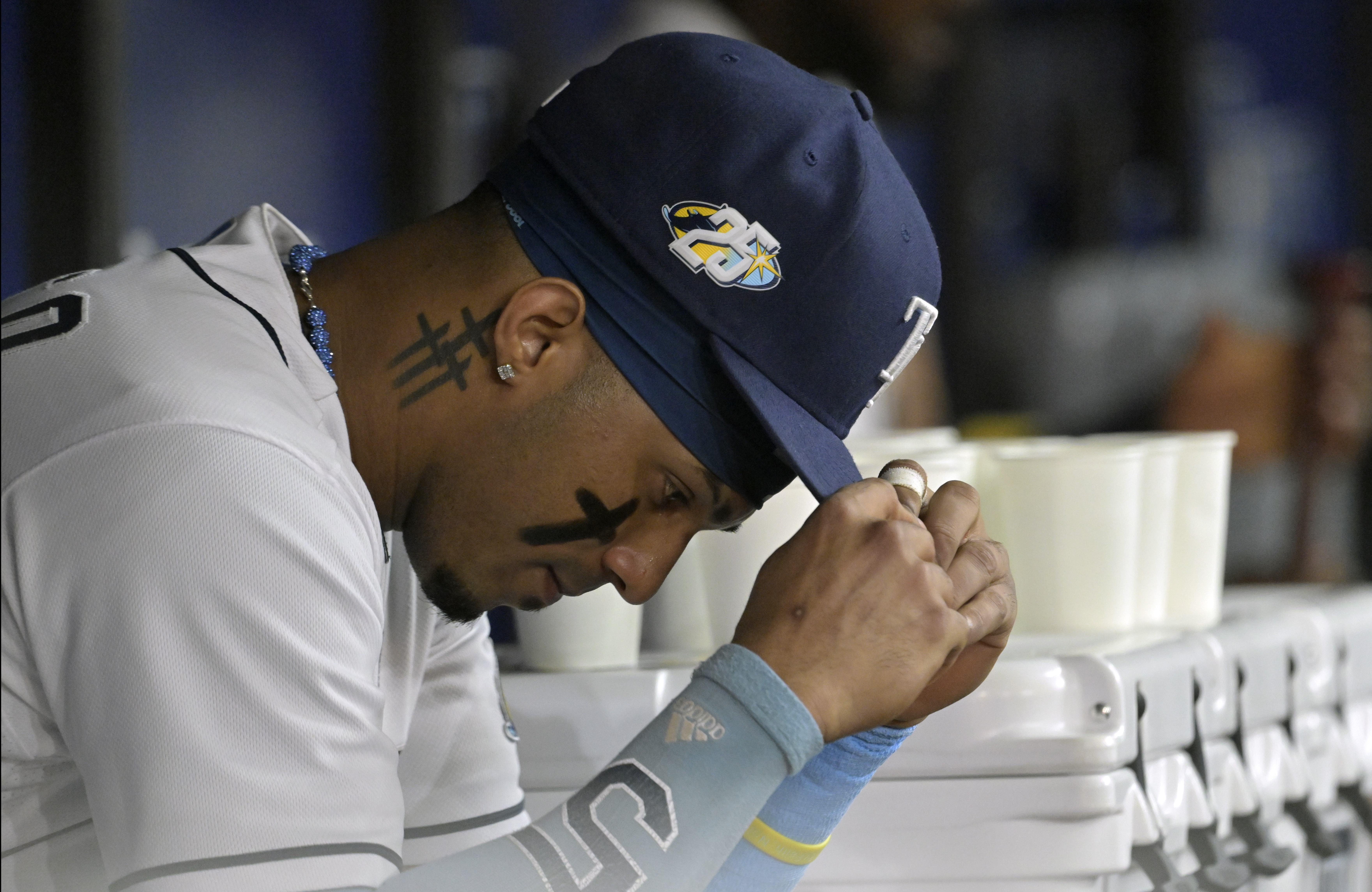 Tampa Bay Rays' Wander Franco, left, and Vidal Brujan, wearing a Arozarena  promotional give-away jerseys, switch places during batting practice before  a baseball game against the Kansas City Royals Saturday, June 24