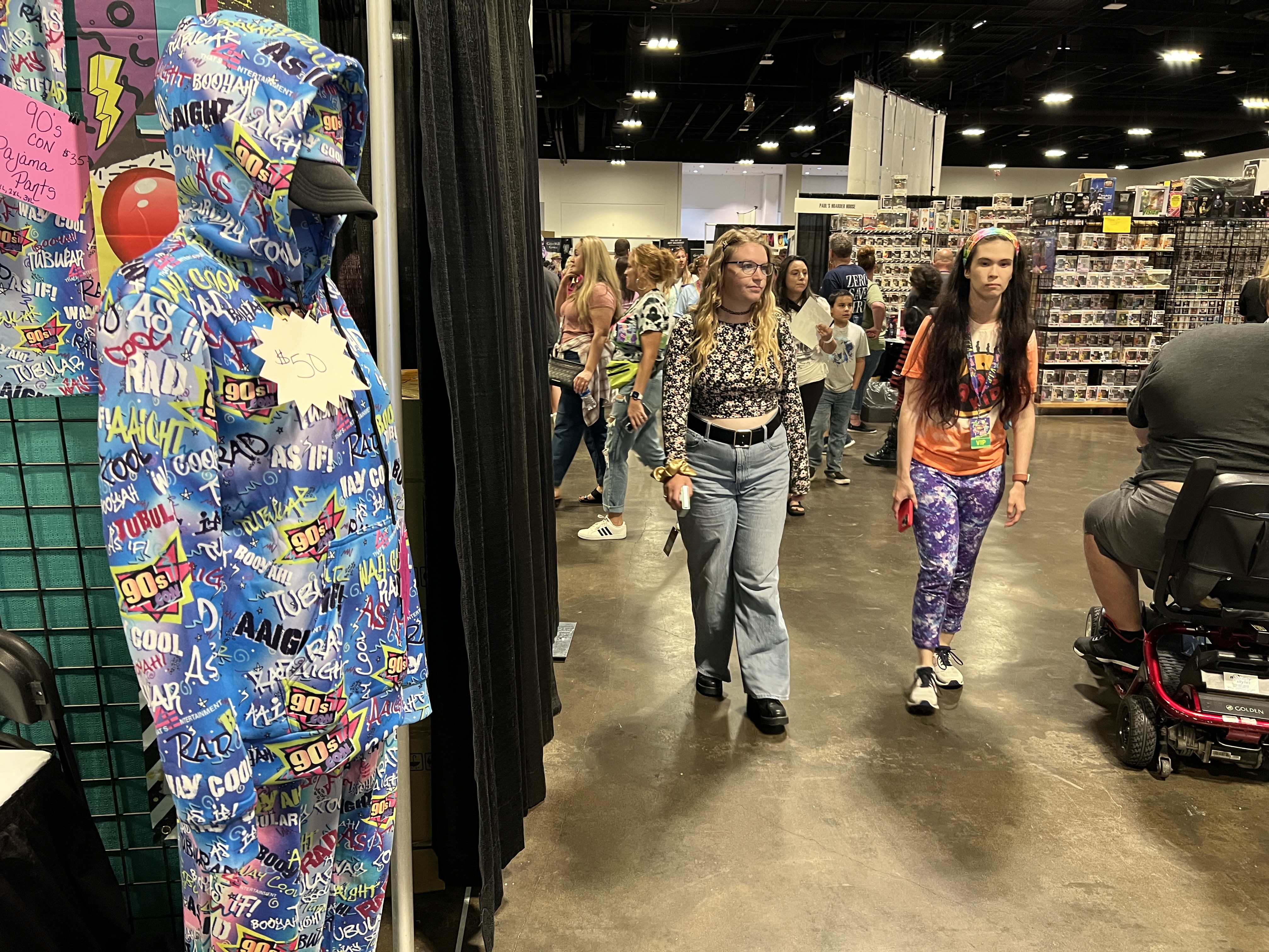 Visitors to 90s Con at Tampa Convention Center on Sunday, Sept. 17, 2023 walk past vendor booths.