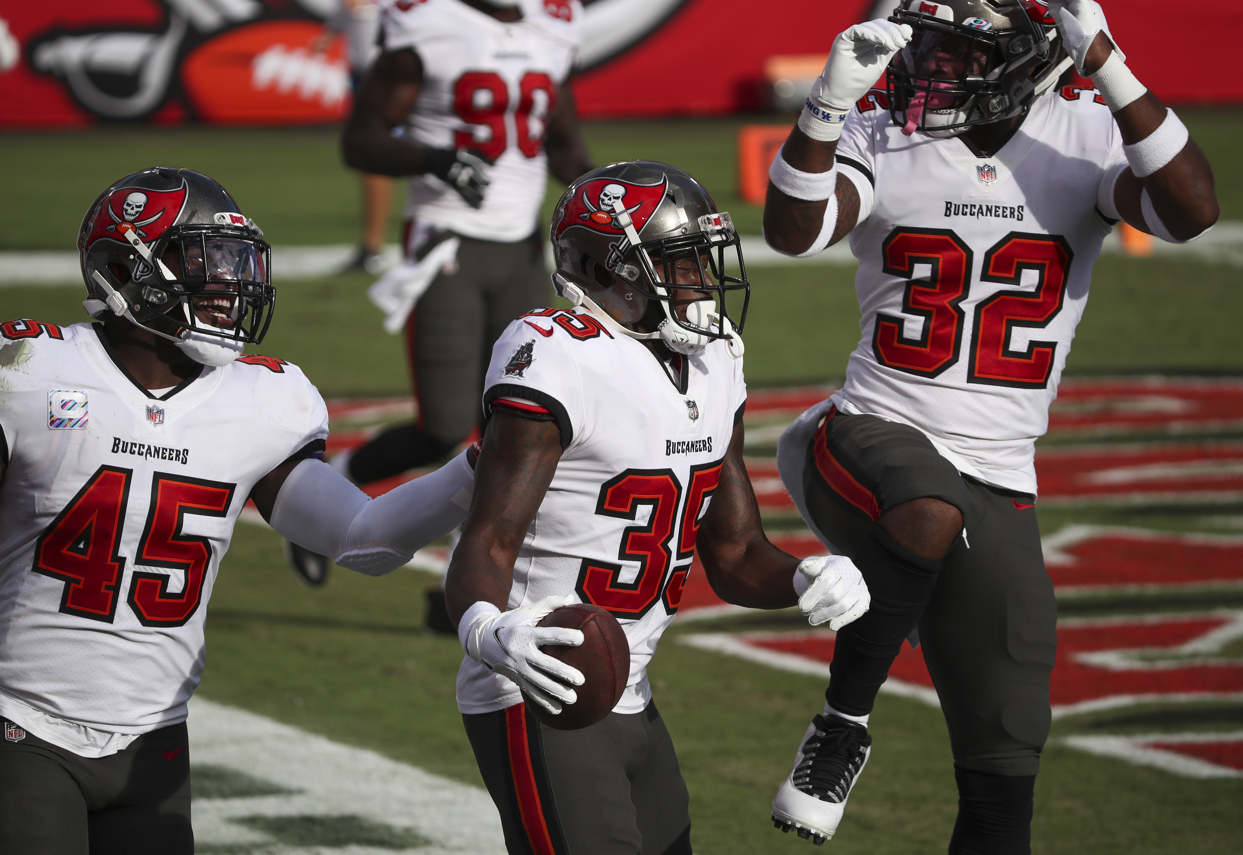 Green Bay Packers' Jamaal Williams is stopped by Tampa Bay Buccaneers'  Carlton Davis (24) and D …