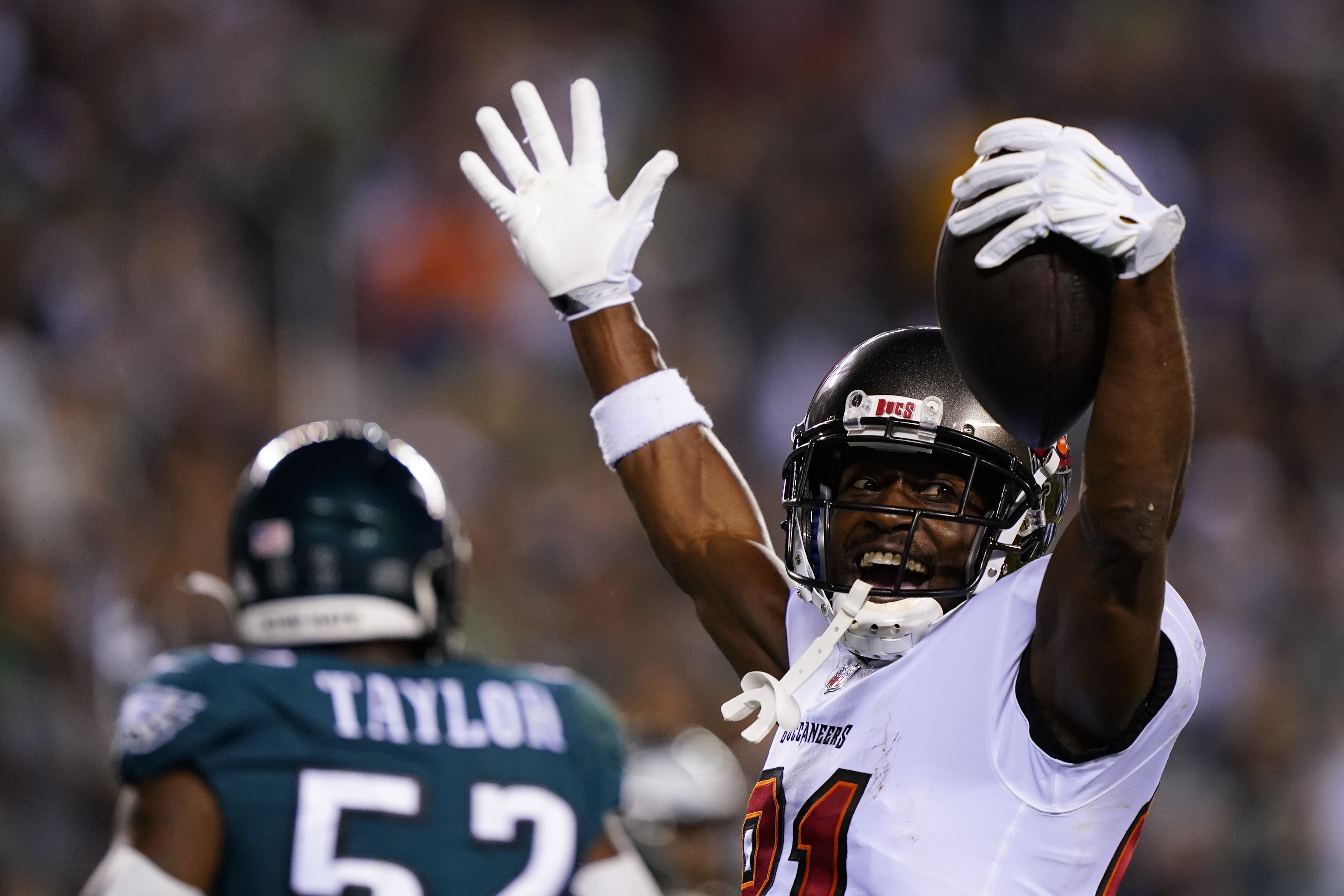 Philadelphia Eagles free safety Anthony Harris (28) runs with the ball as  Tampa Bay Buccaneers wide receiver Antonio Brown (81) tries to stop him  during the first half of an NFL football