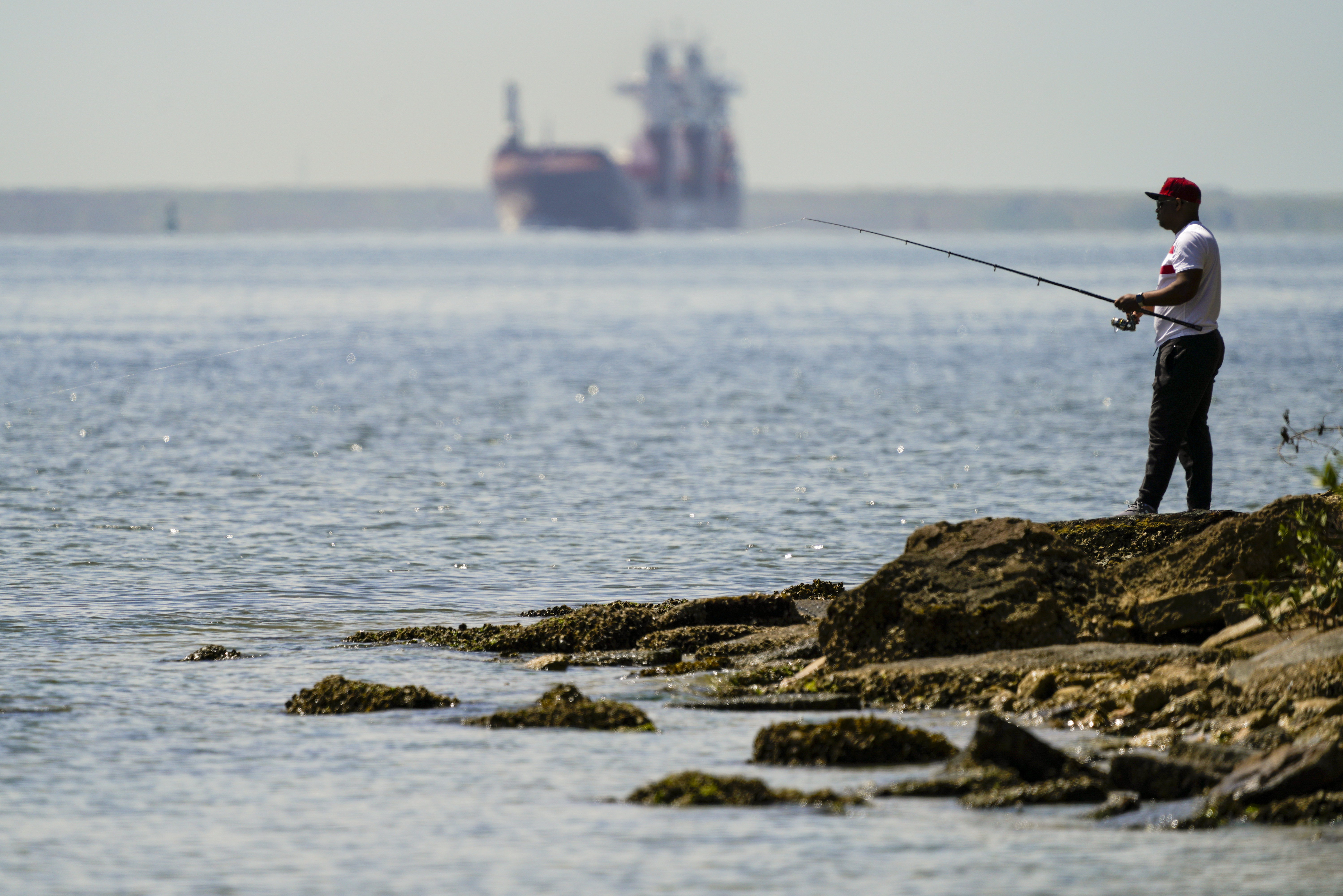 Angler casting a fishing line over the r, Stock Video