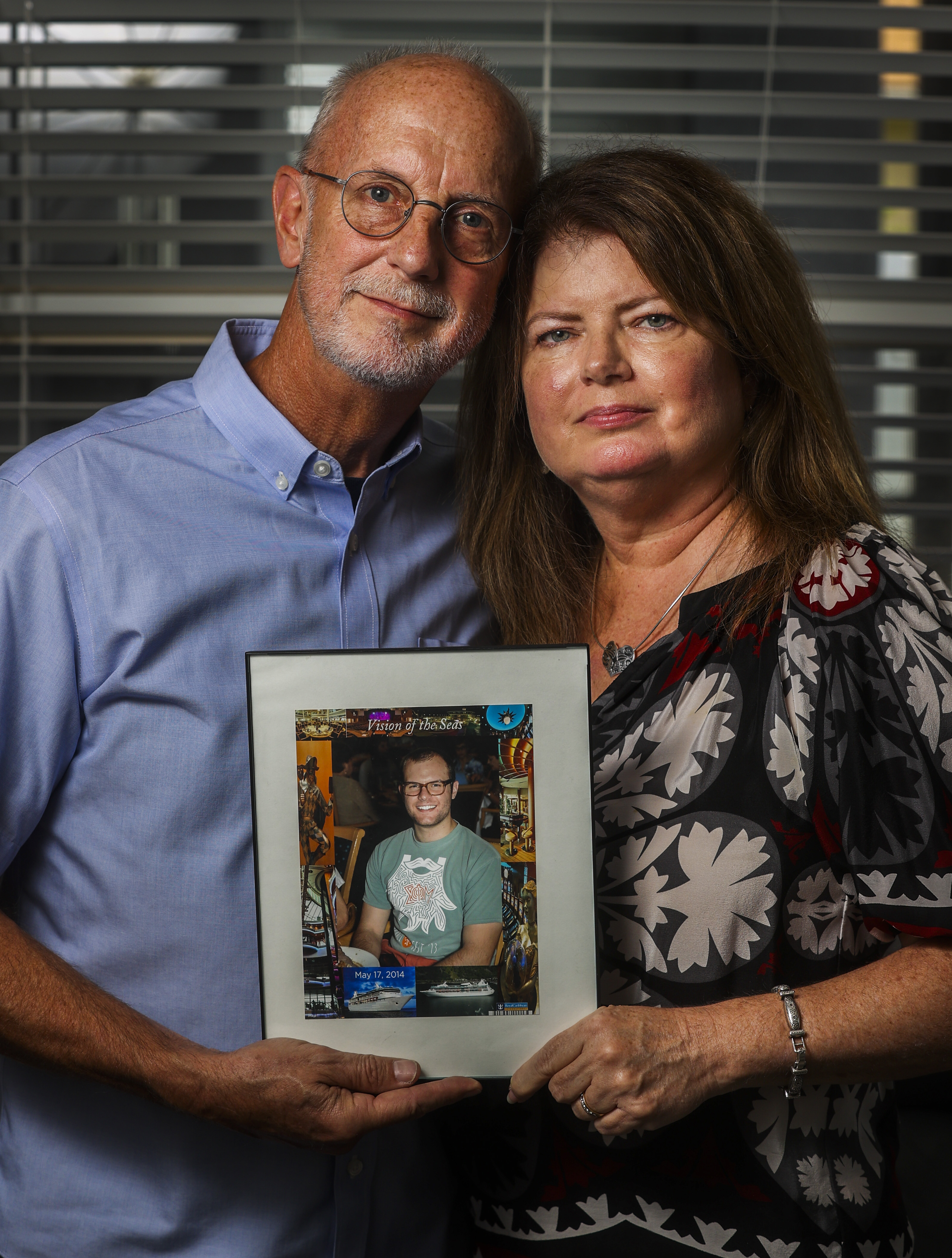 Karen and Zayne Larsen hold a photo of their son, Luke, who died in
                                    their Valrico home after using kratom. He was 27.