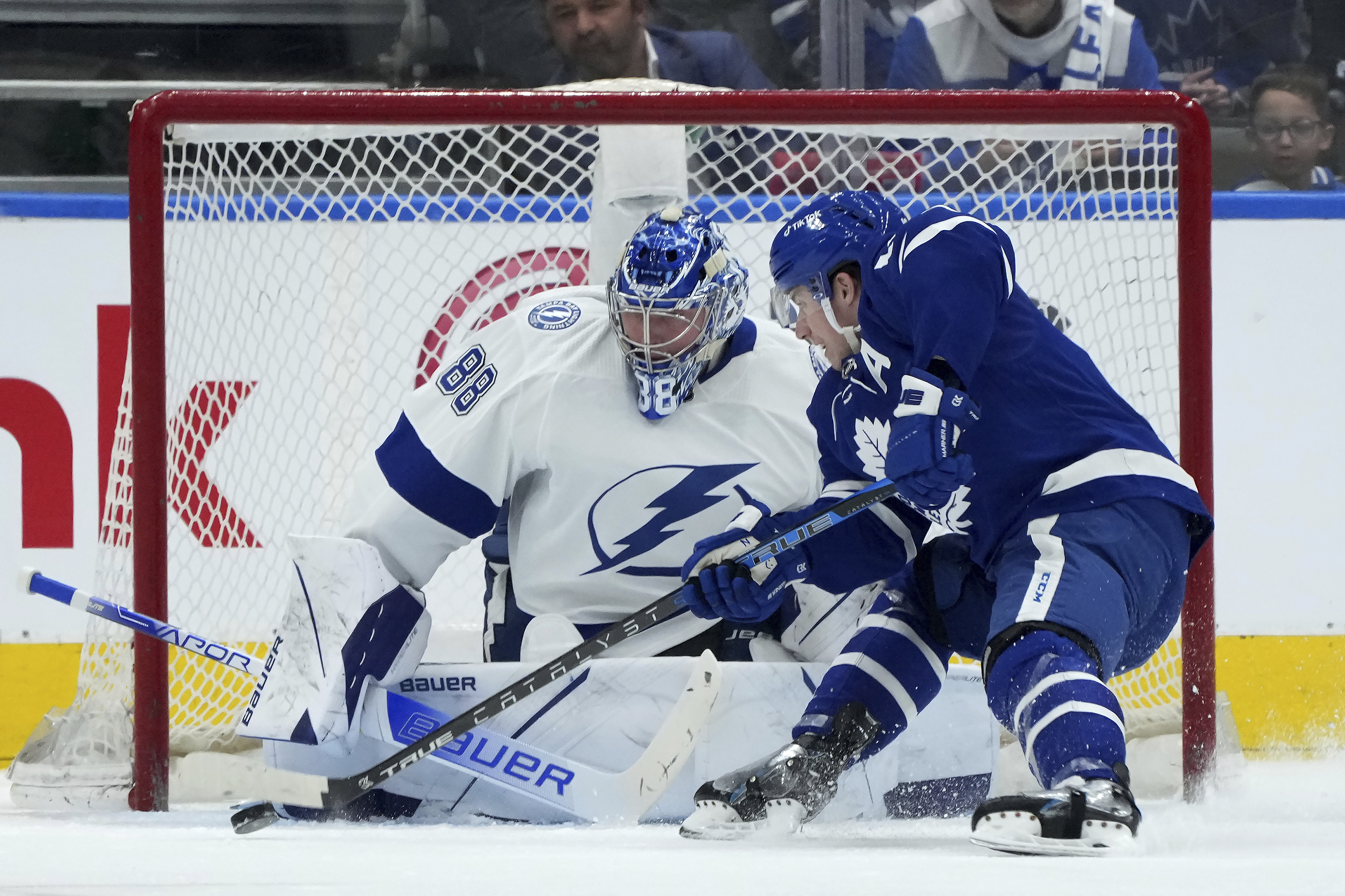 Toronto Maple Leafs forward Mitch Marner, eft, shoots as Maple