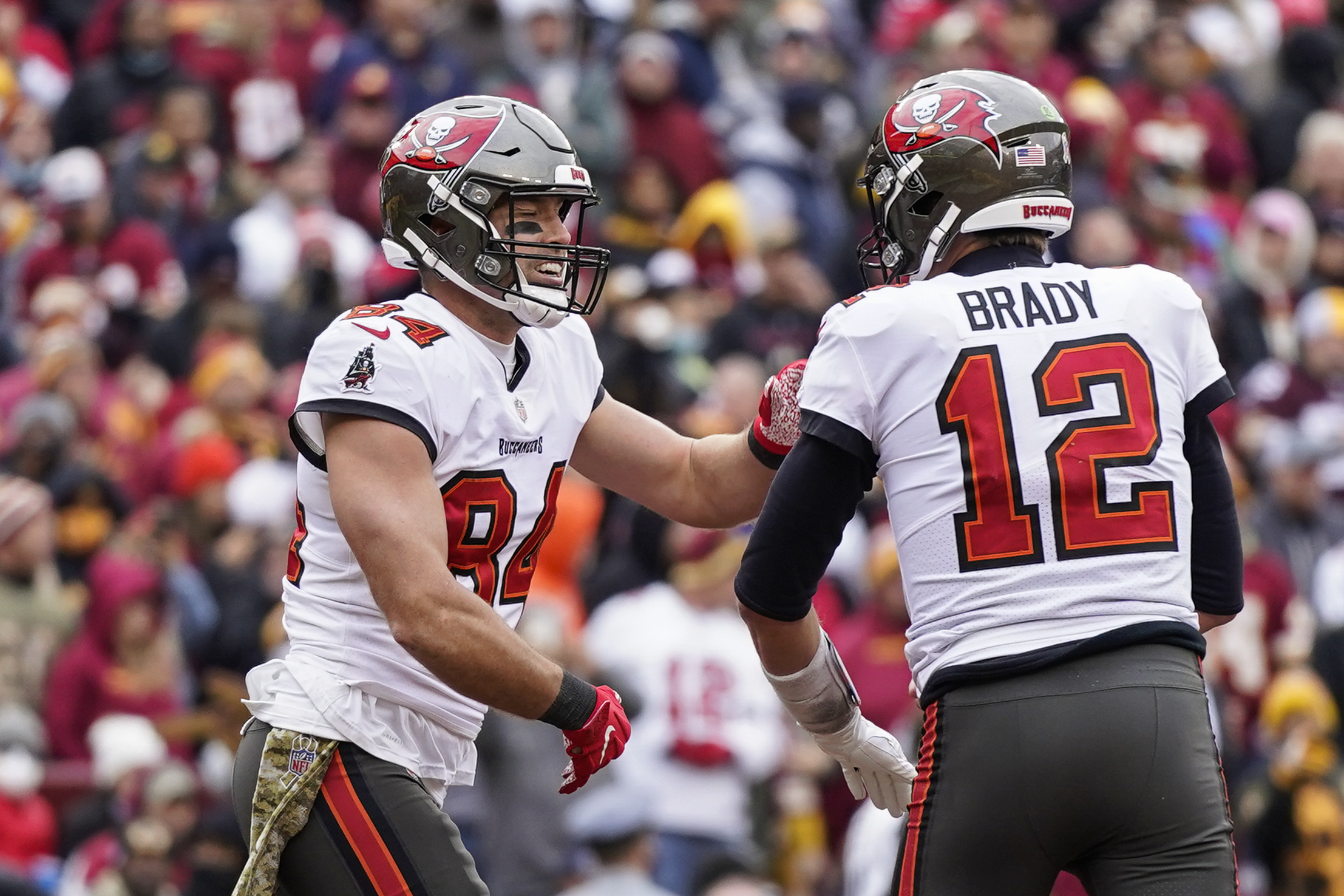 Nov 14, 2021; Landover, MD USA; Washington Football Team quarterback Taylor  Heinicke (4) celebrates after running back Antonio Gibson (24) scores a  touchdown that sealed the victory against the Tampa Bay Buccaneers