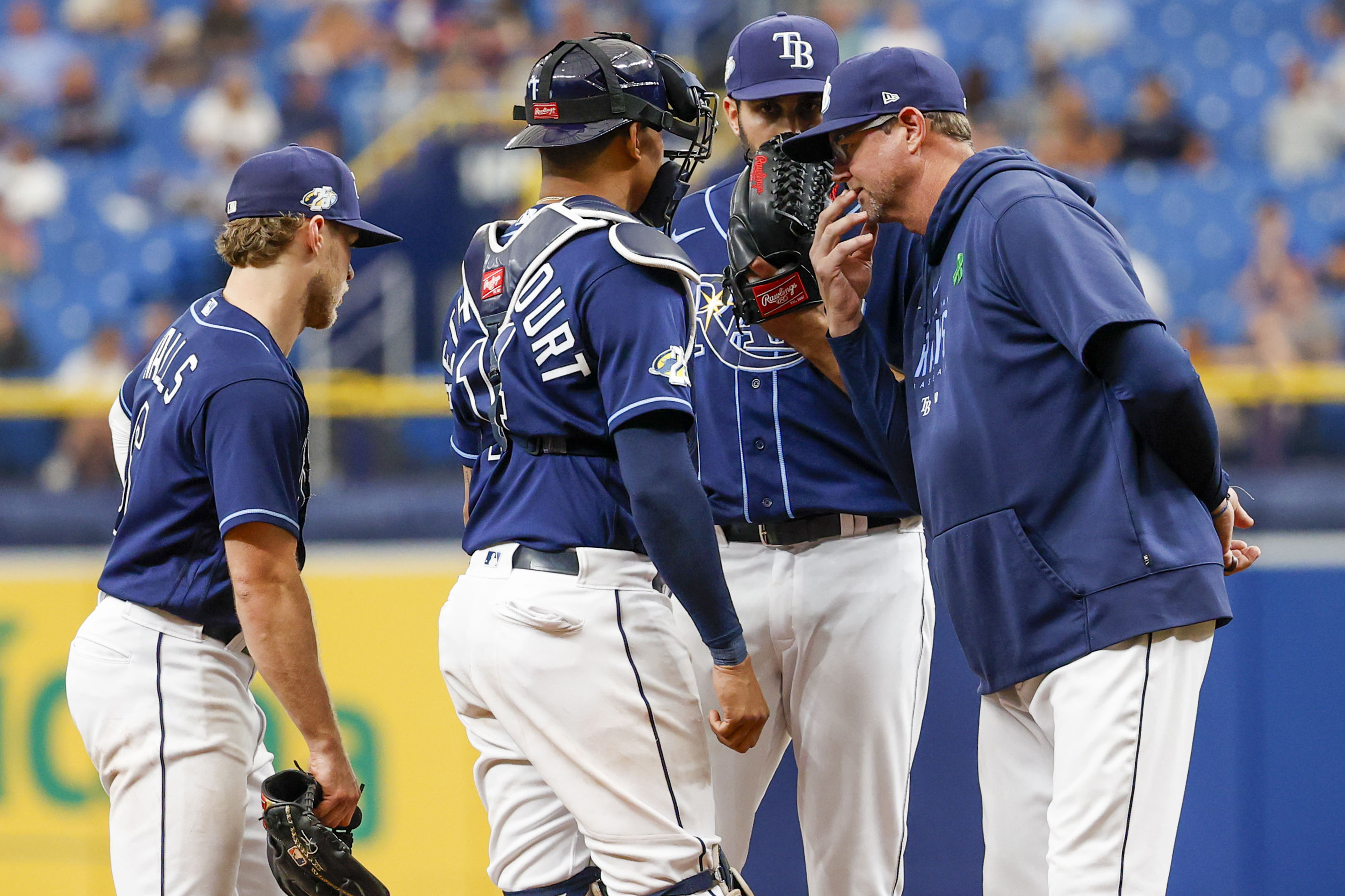 Tampa Bay Rays pitching coach Kyle Snyder, left, looks on as Shane