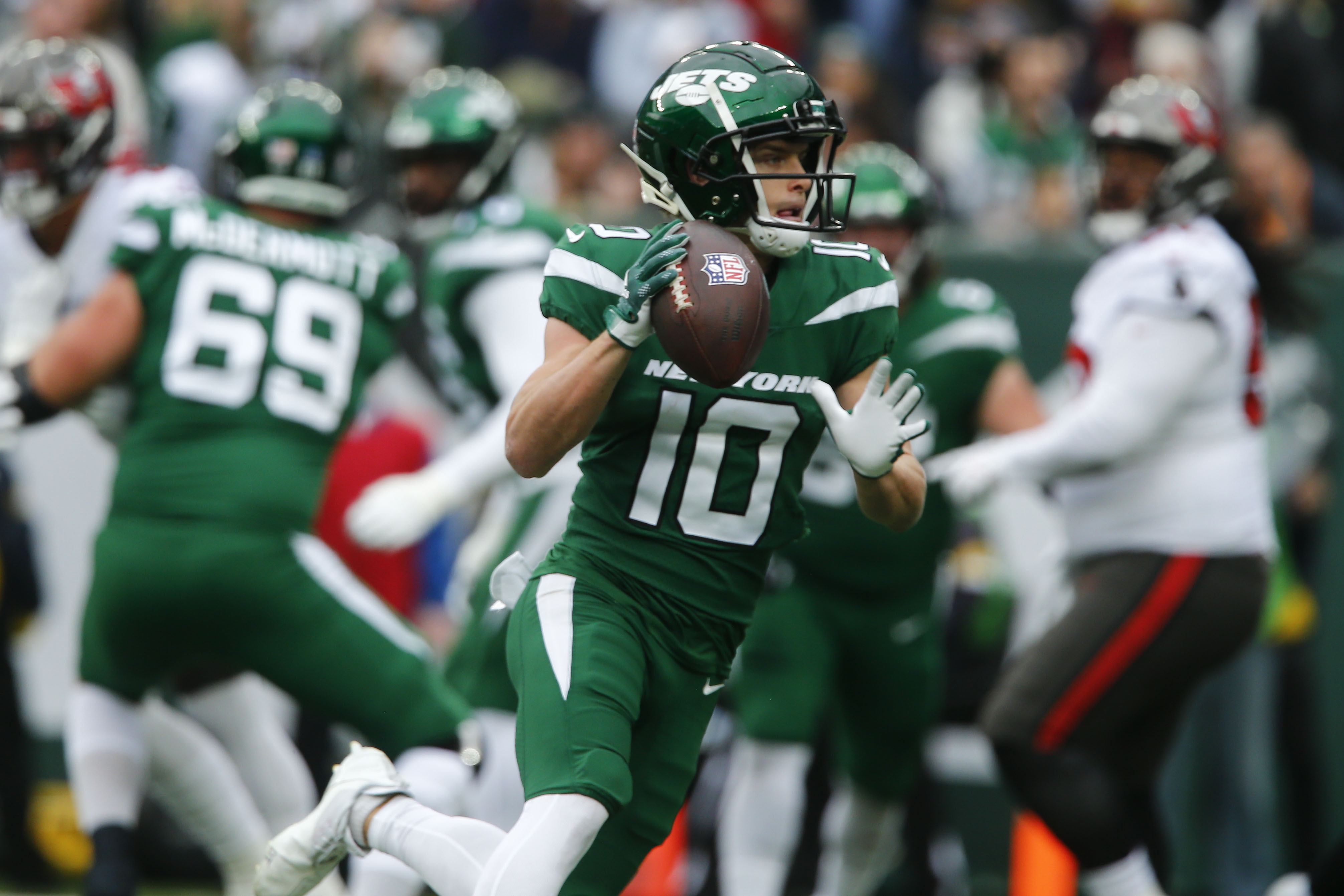 New York Jets running back Michael Carter (32) warms up before taking on  the Miami Dolphins during an NFL football game Sunday, Oct. 9, 2022, in  East Rutherford, N.J. (AP Photo/Adam Hunger