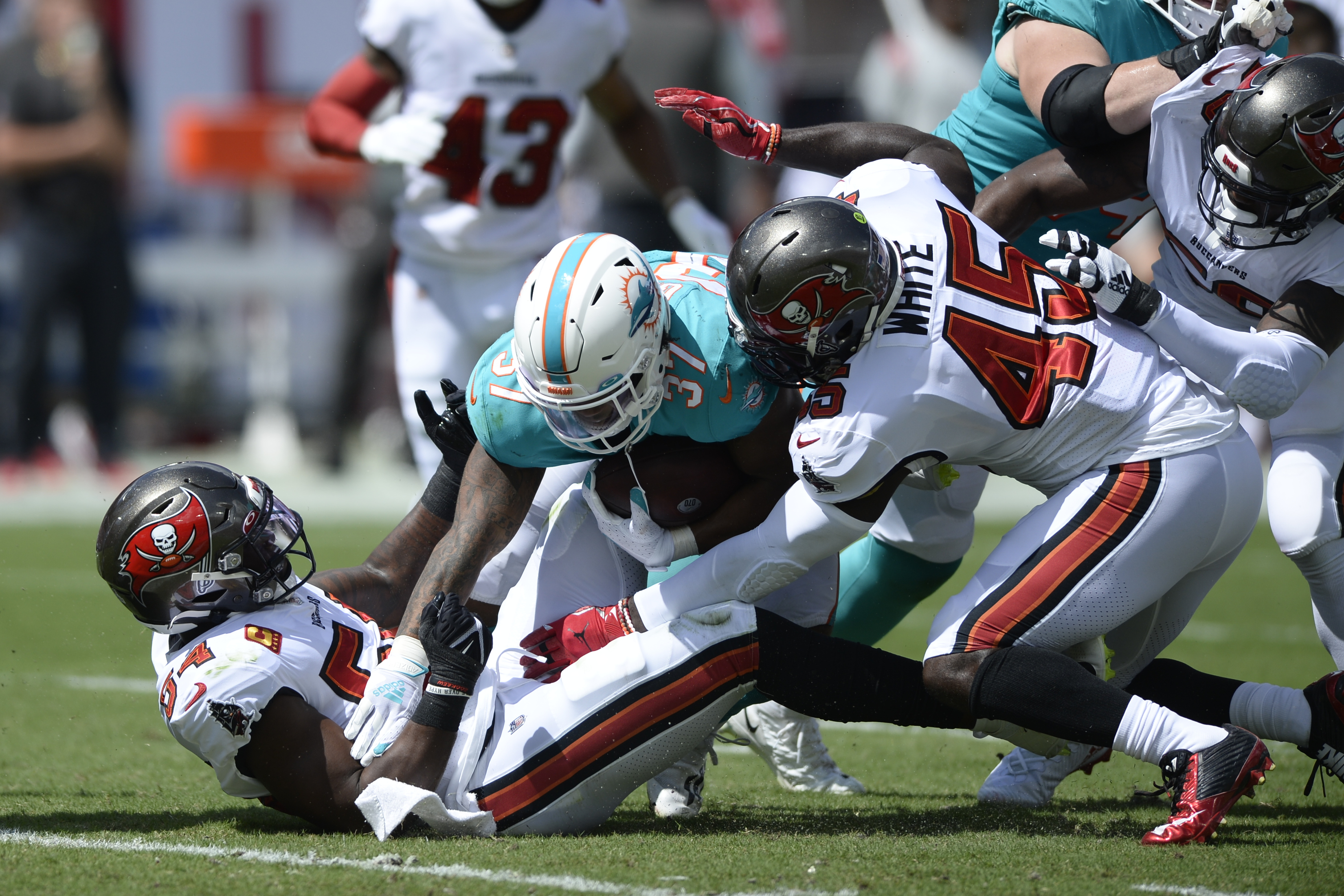 Miami Dolphins running back Myles Gaskin (37) is tackled by