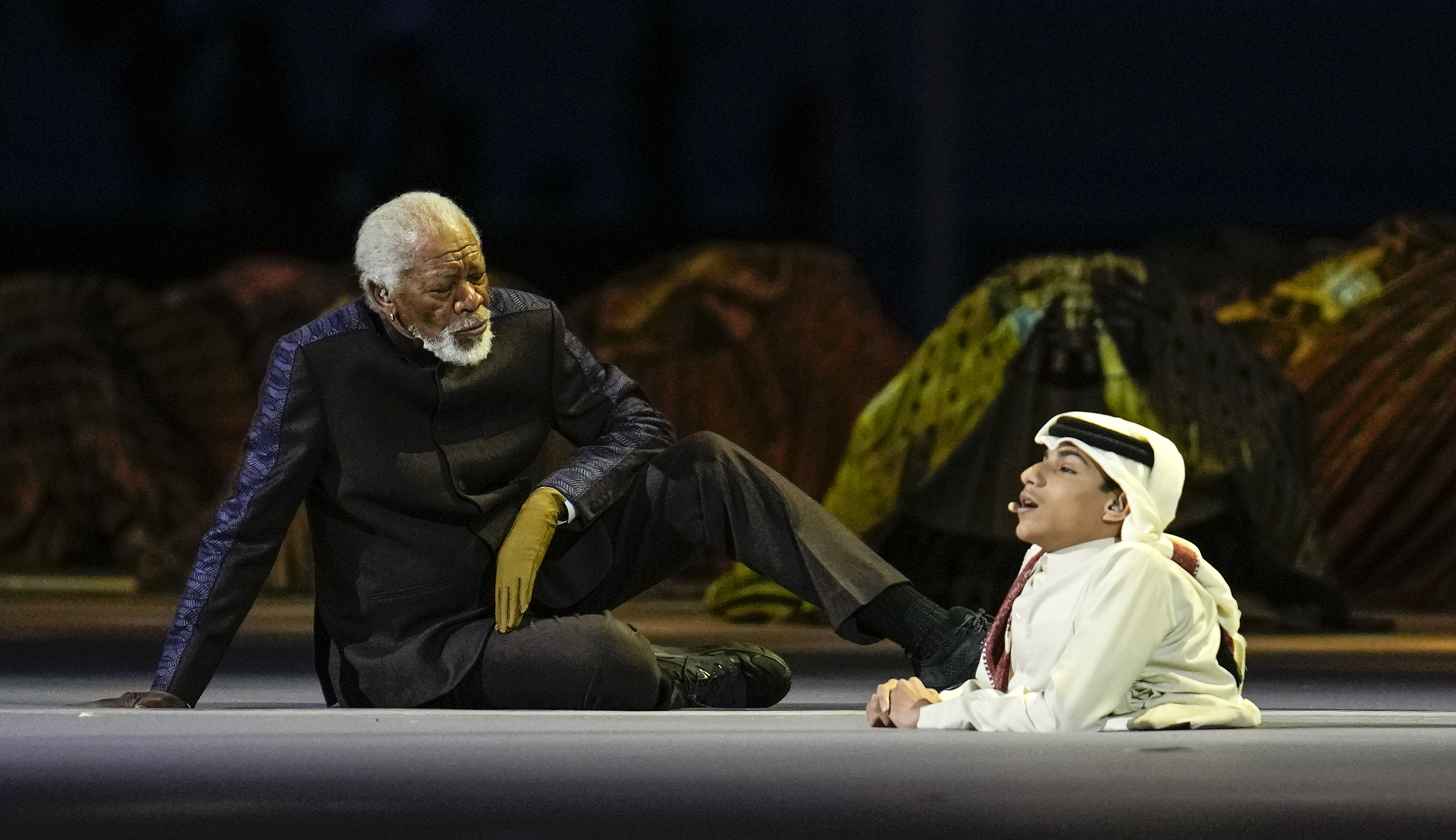 Actor Morgan Freeman, left, sits on the stage during the opening ceremony prior to the World Cup match between Qatar and Ecuador at the Al Bayt Stadium in Al Khor.