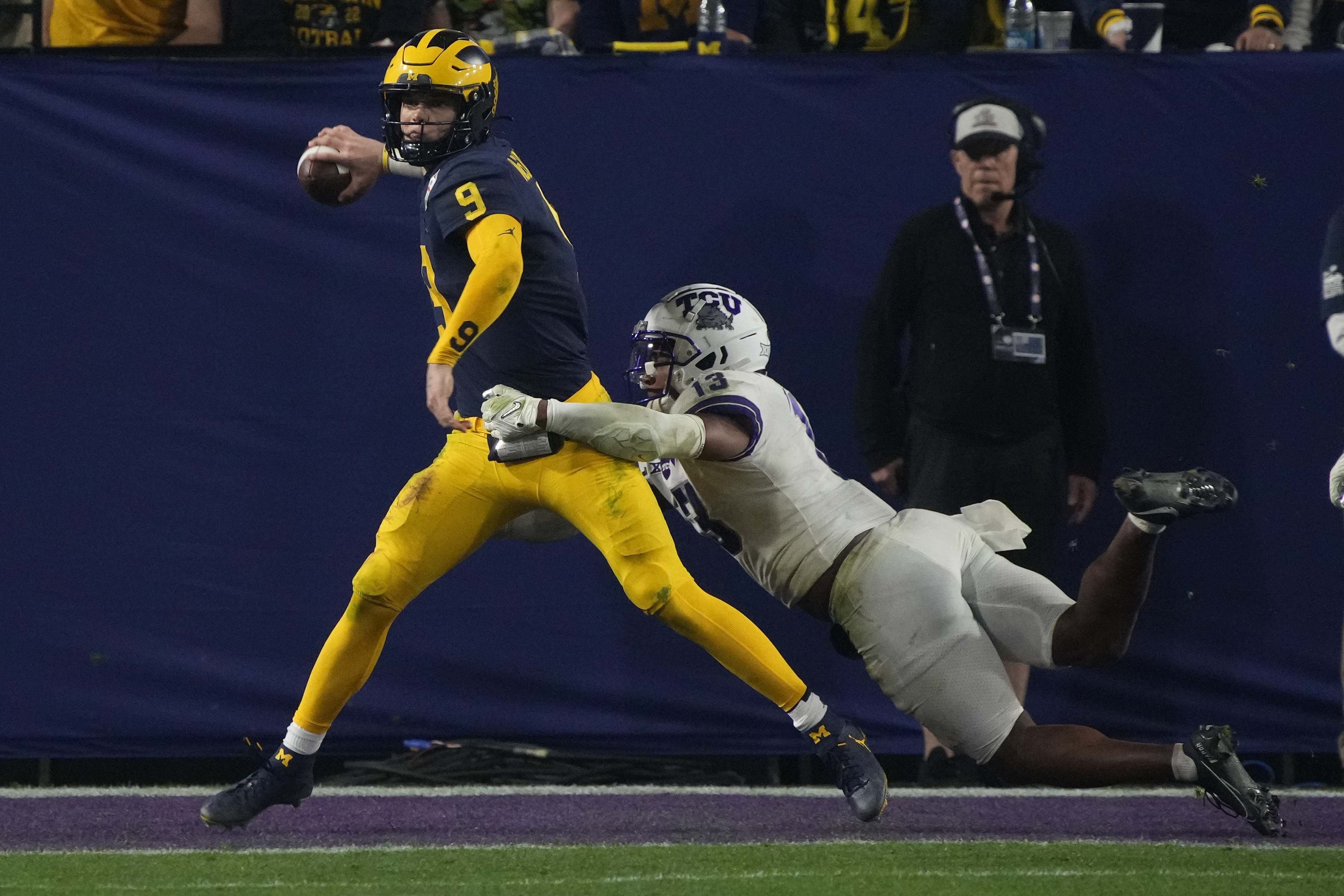 December 31, 2022 Michigan Wolverines wide receiver A.J. Henning #3 carries  the ball and is tackled by TCU Horned Frogs linebacker Dee Winters #13  during the semi-final playoff football game between the