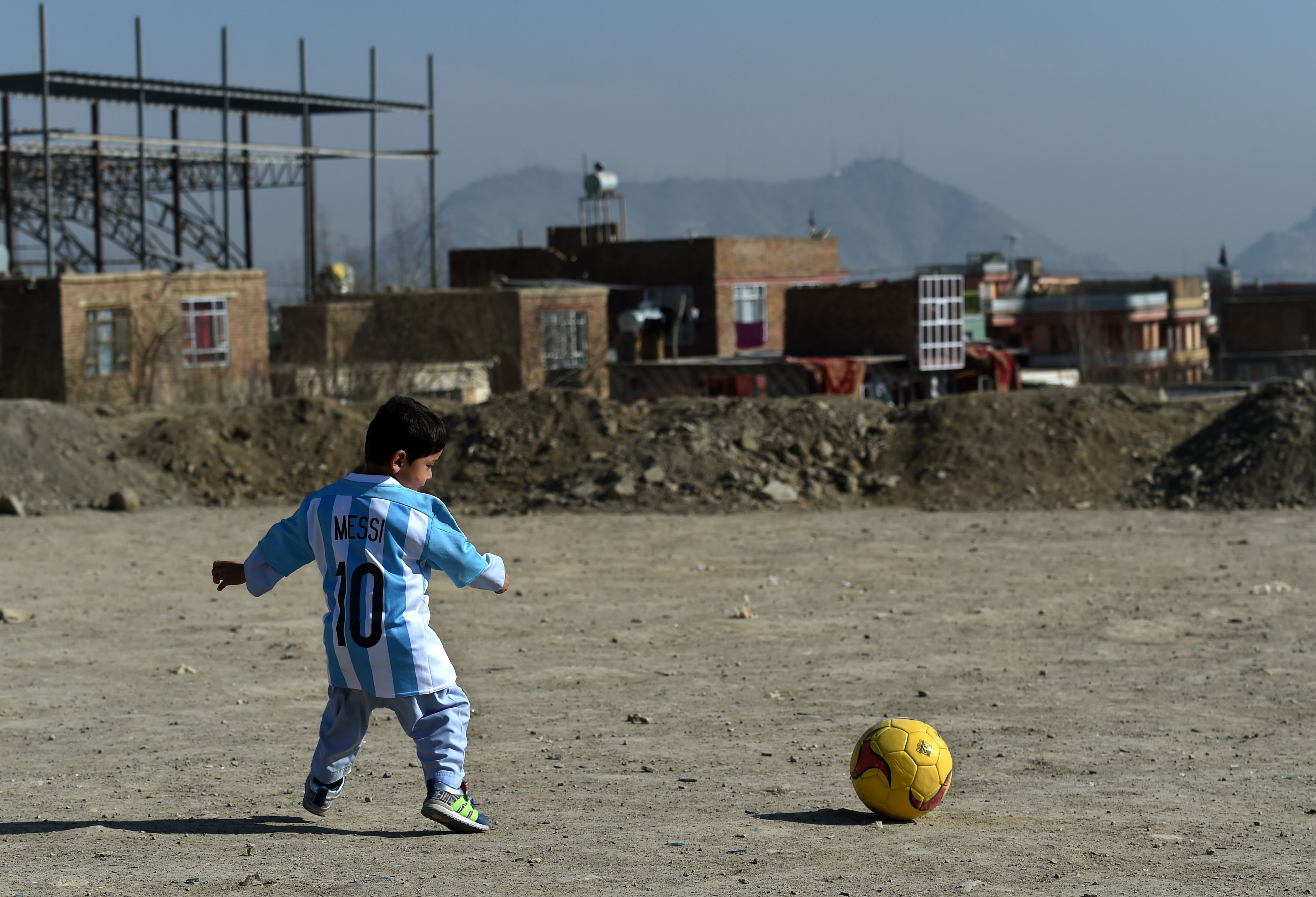 Five-year-old Murtaza Ahmadi pictured wearing homemade 'Messi 10