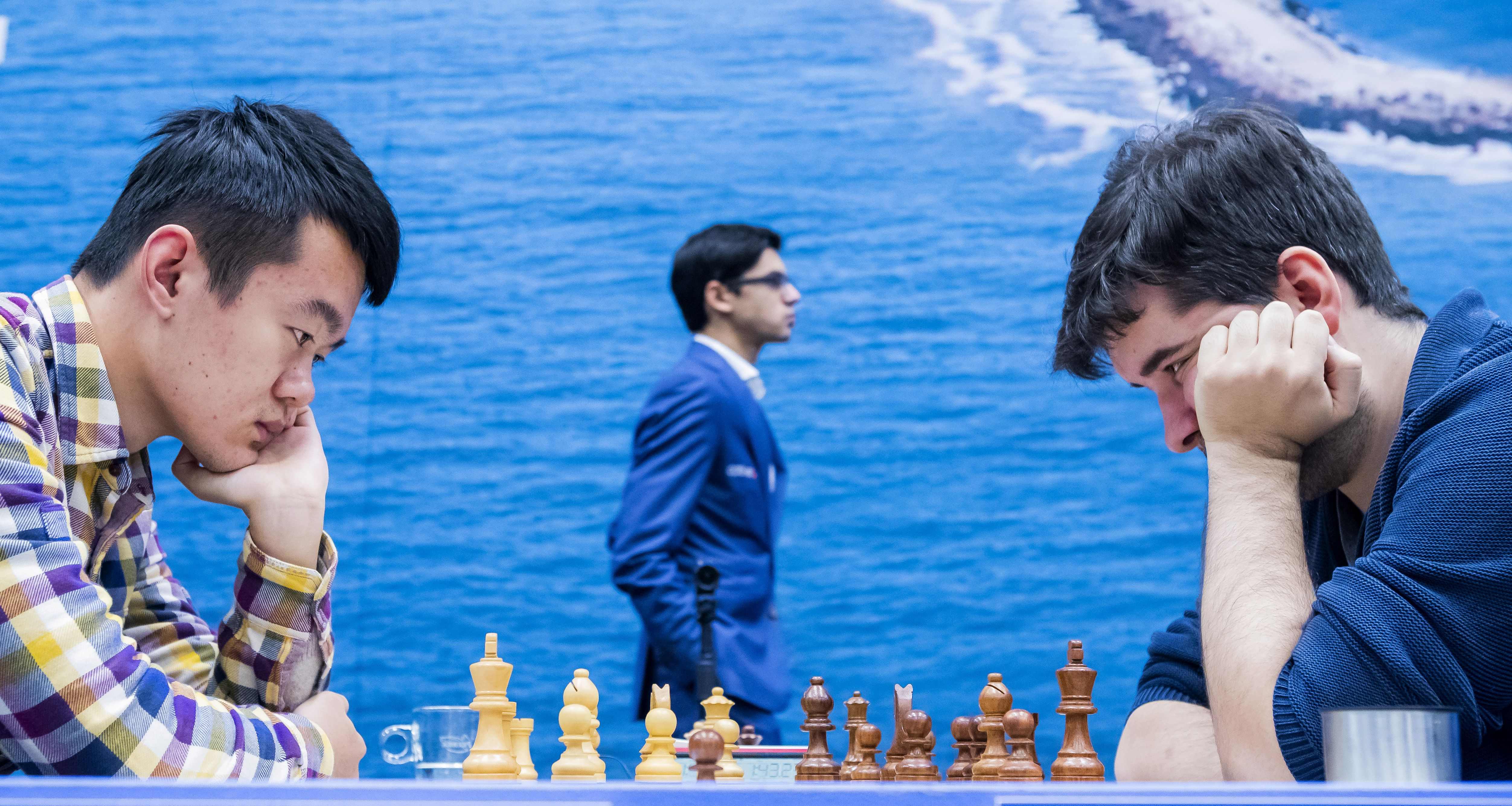 Magnus Carlsen at Tata Steel Chess 2019, Anish Giri walking…