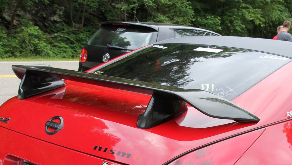 Why do more cars now have a short spoiler above their rear window?