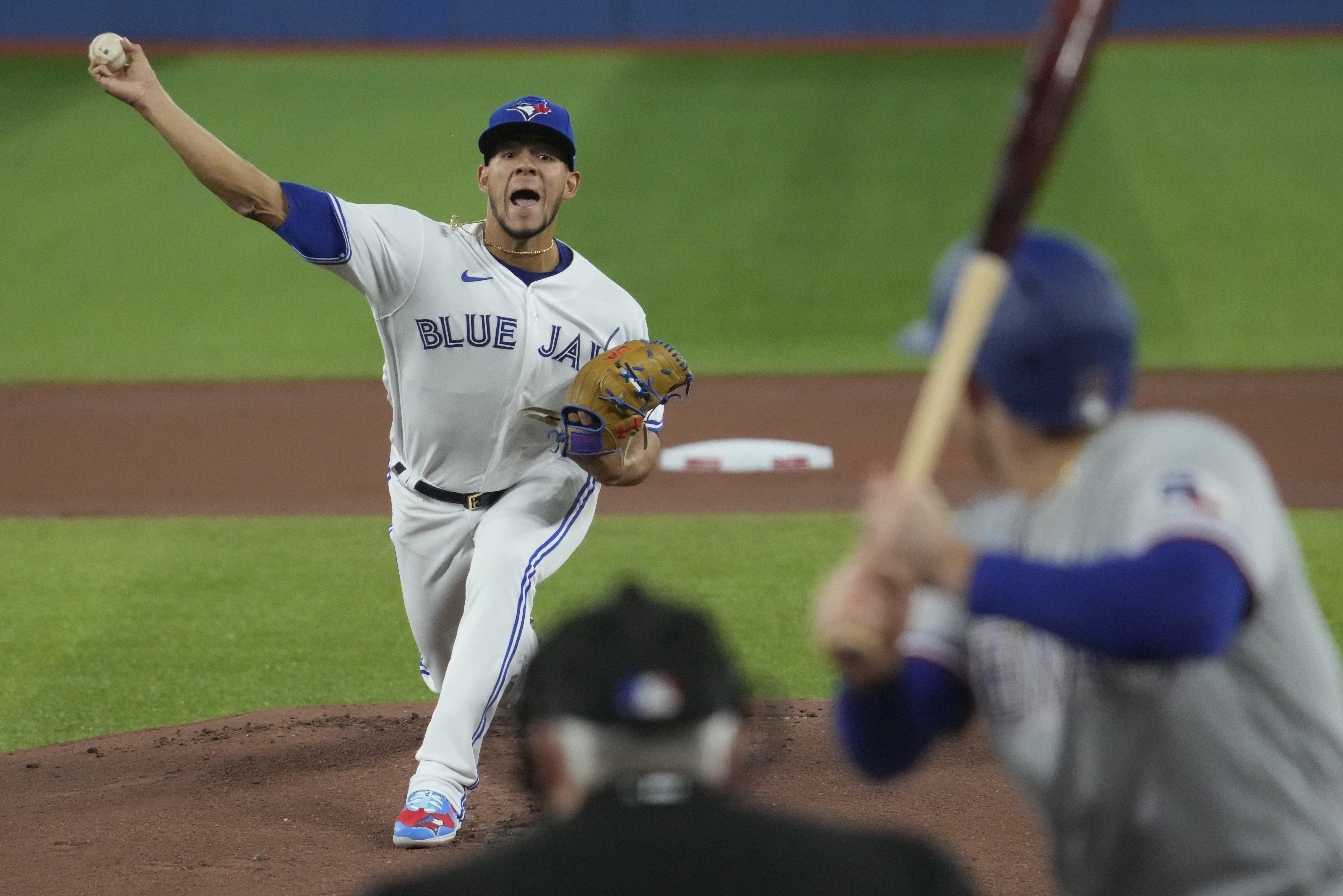 Members of the Blue Jays put their hats back on after the national anthem  during the opening da …