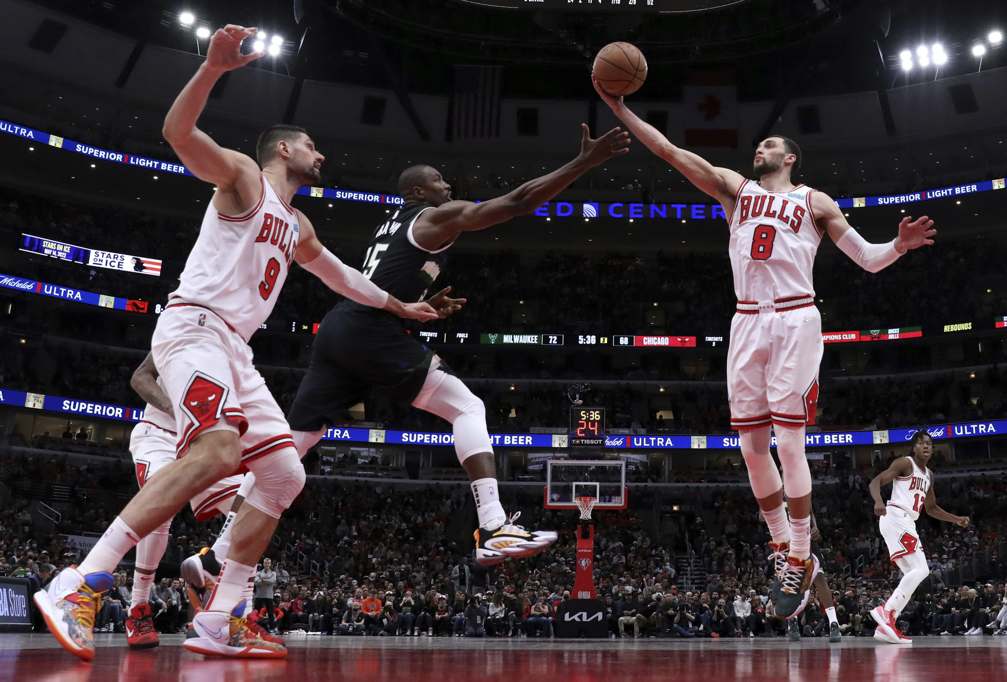 CHICAGO, IL - DECEMBER 14: Chicago Bulls Guard Zach LaVine (8) shoots a  three point basket during a NBA game between the New York Knicks and the  Chicago Bulls on December 14