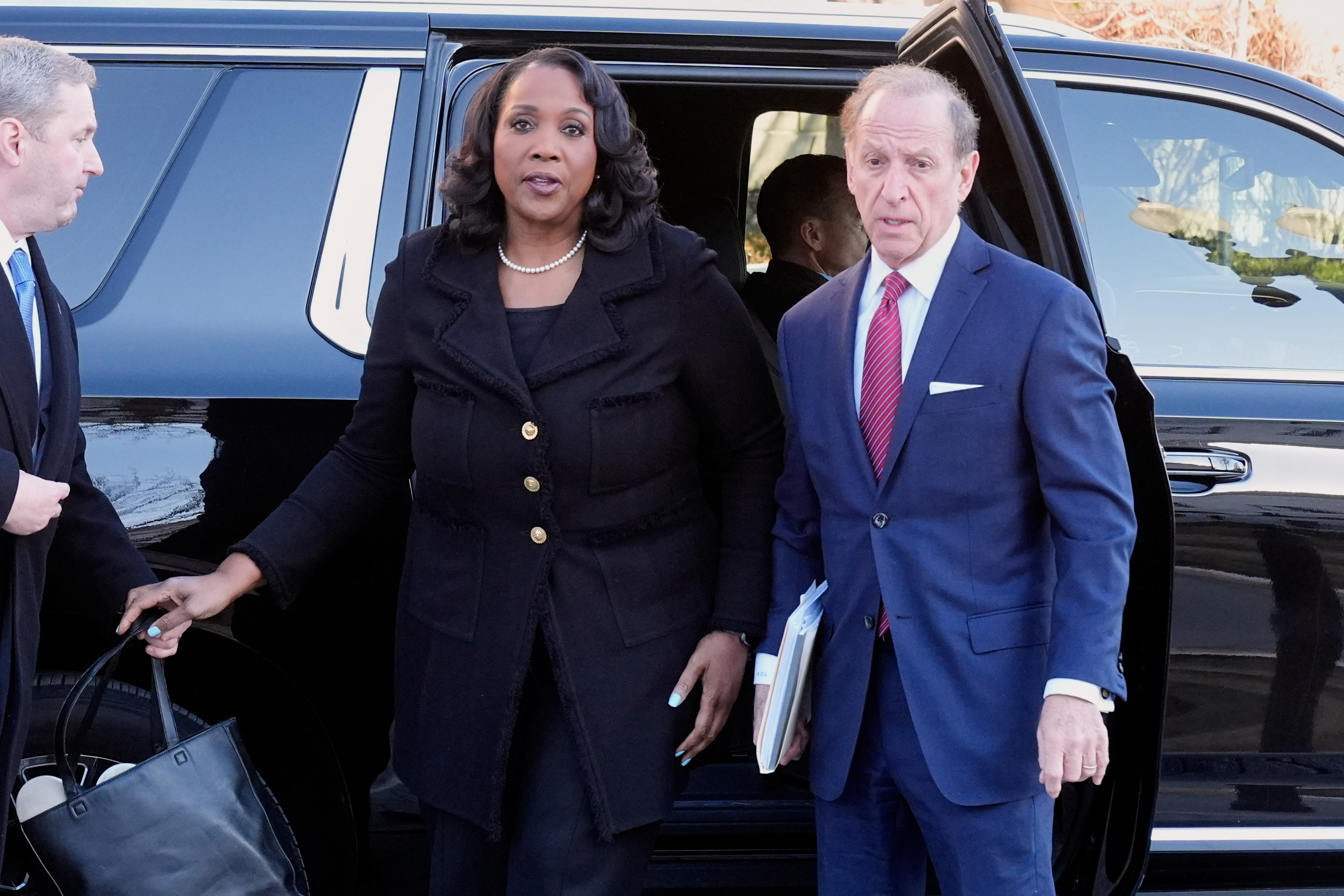 Federal Reserve governor Lisa Cook and attorney Abbe Lowell arrive at the Supreme Court in January. (Mark Schiefelbein/AP)