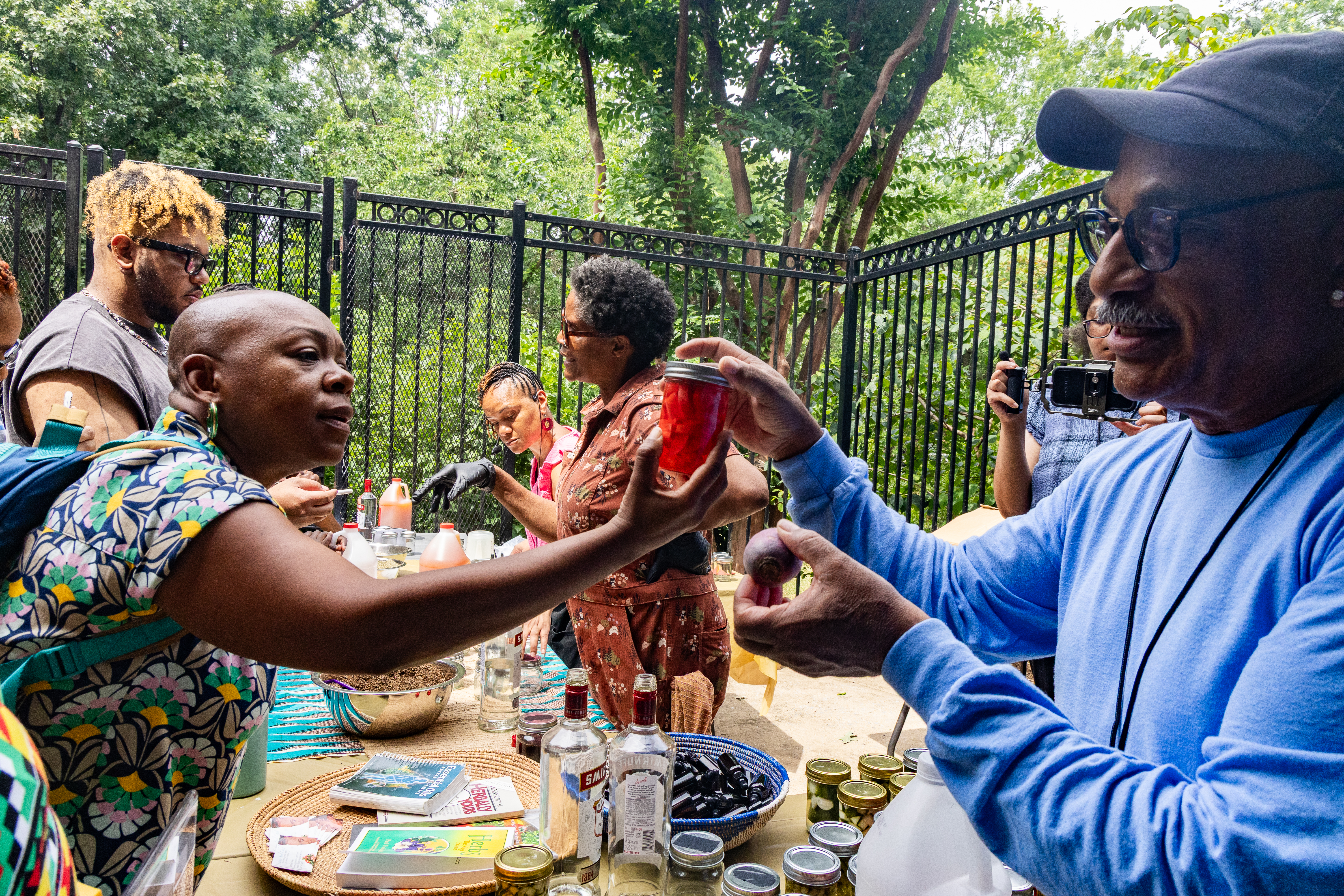 Derek Thomas, who heads the community gardening program at the Anacostia Community Museum, leads a presentation on fermenting at the museum's Juneteenth celebration Friday. (Hanna Leka/For The Washington Post)