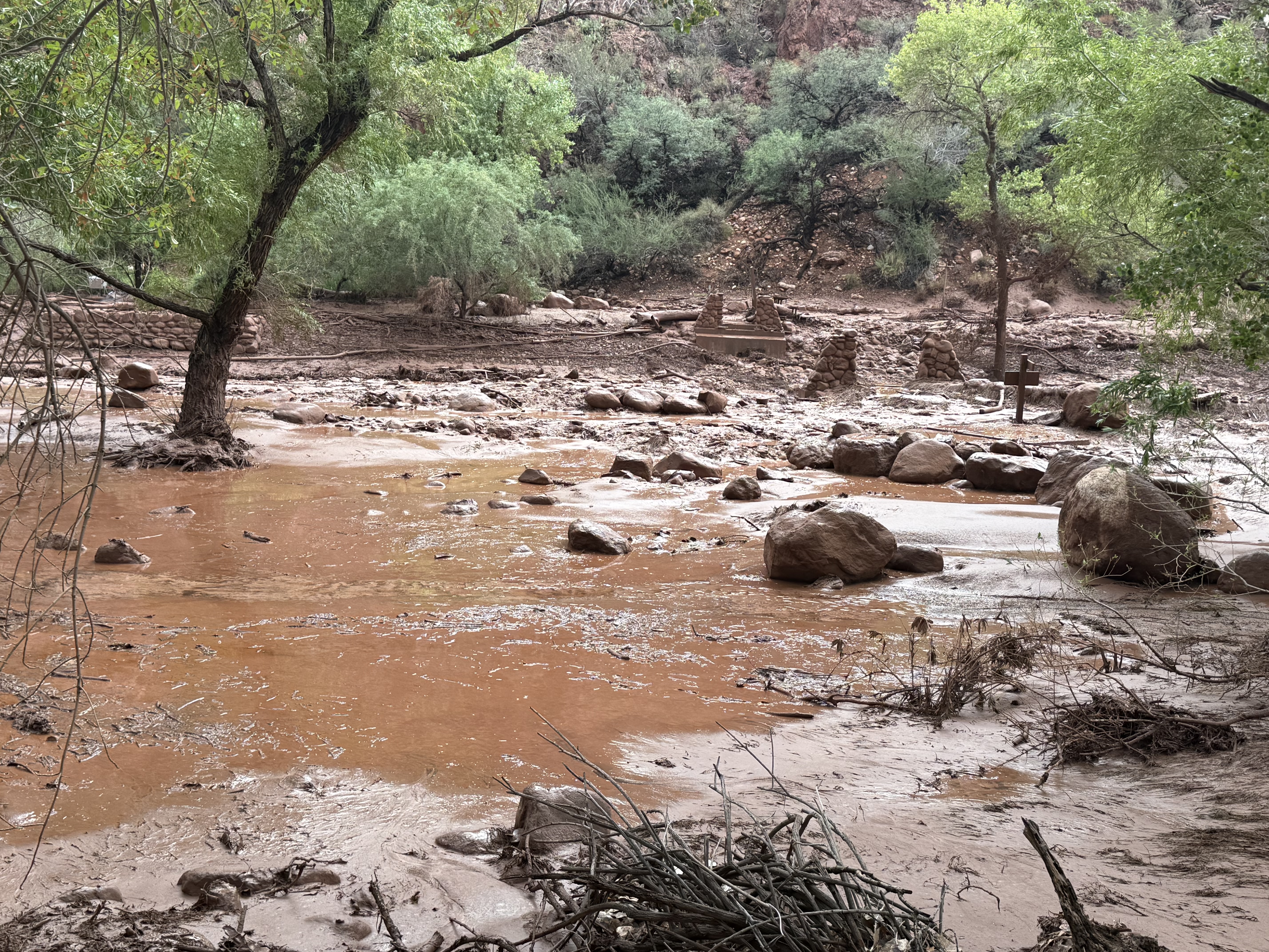 Remnants of stone bridge pylons remain along Bright Angel Creek after a flash flood destroyed the footbridge Saturday. (J. Thompson/NPS)