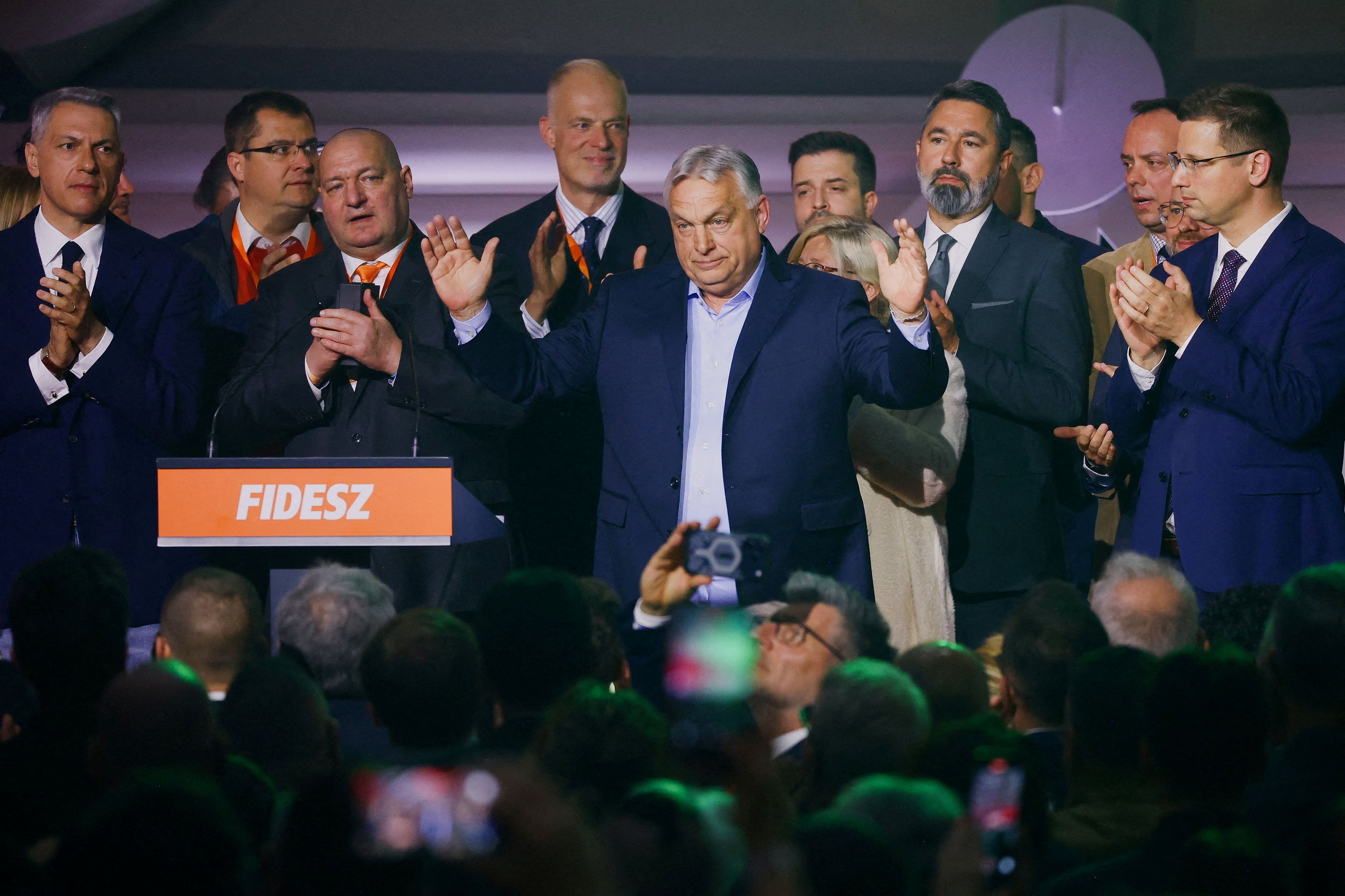 Hungarian Prime Minister Viktor Orban reacts onstage Sunday in Budapest after the announcement of partial parliamentary election results. (Bernadett Szabo/Reuters)