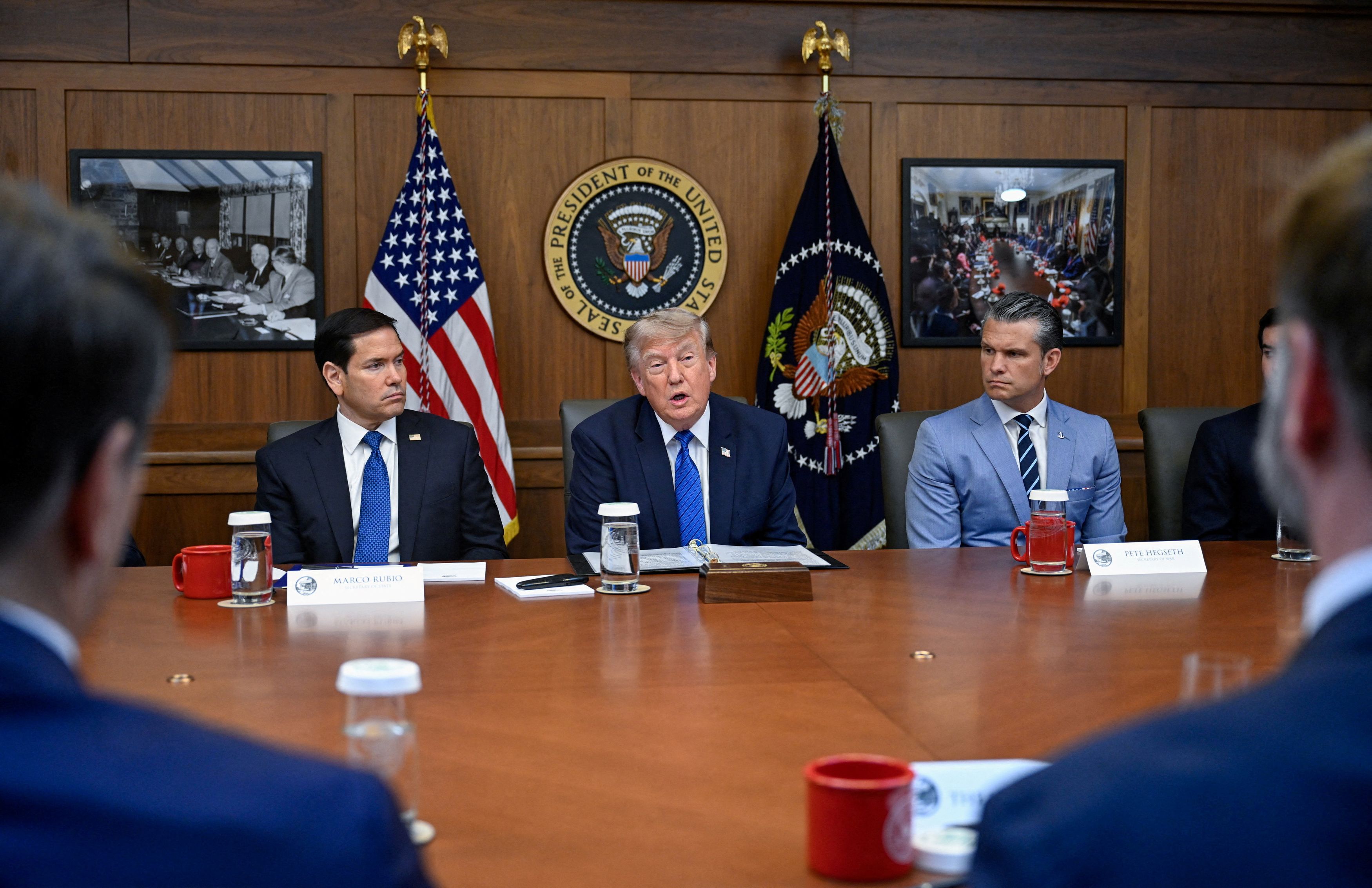 President Donald Trump leads a rare Camp David Cabinet meeting Friday, flanked by Secretary of State Marco Rubio, left, and Defense Secretary Pete Hegseth. (Daniel Heuer/Reuters)