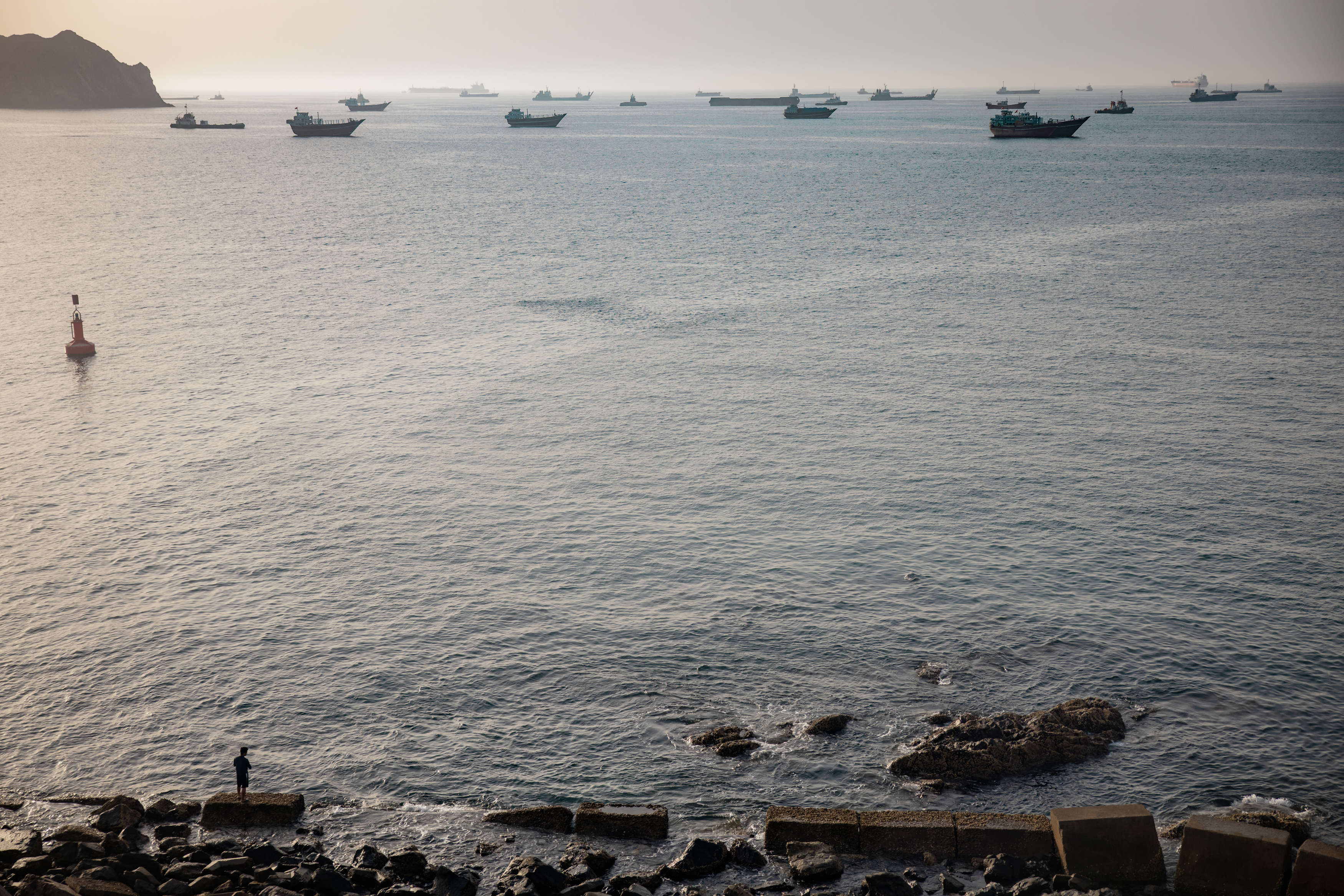 Oil tankers, cargo carriers, commercial vessels and traditional Omani fishing boats remain anchored off Qaboos Port in Muscat, Oman, on Friday. (Elke Scholiers/Getty Images)