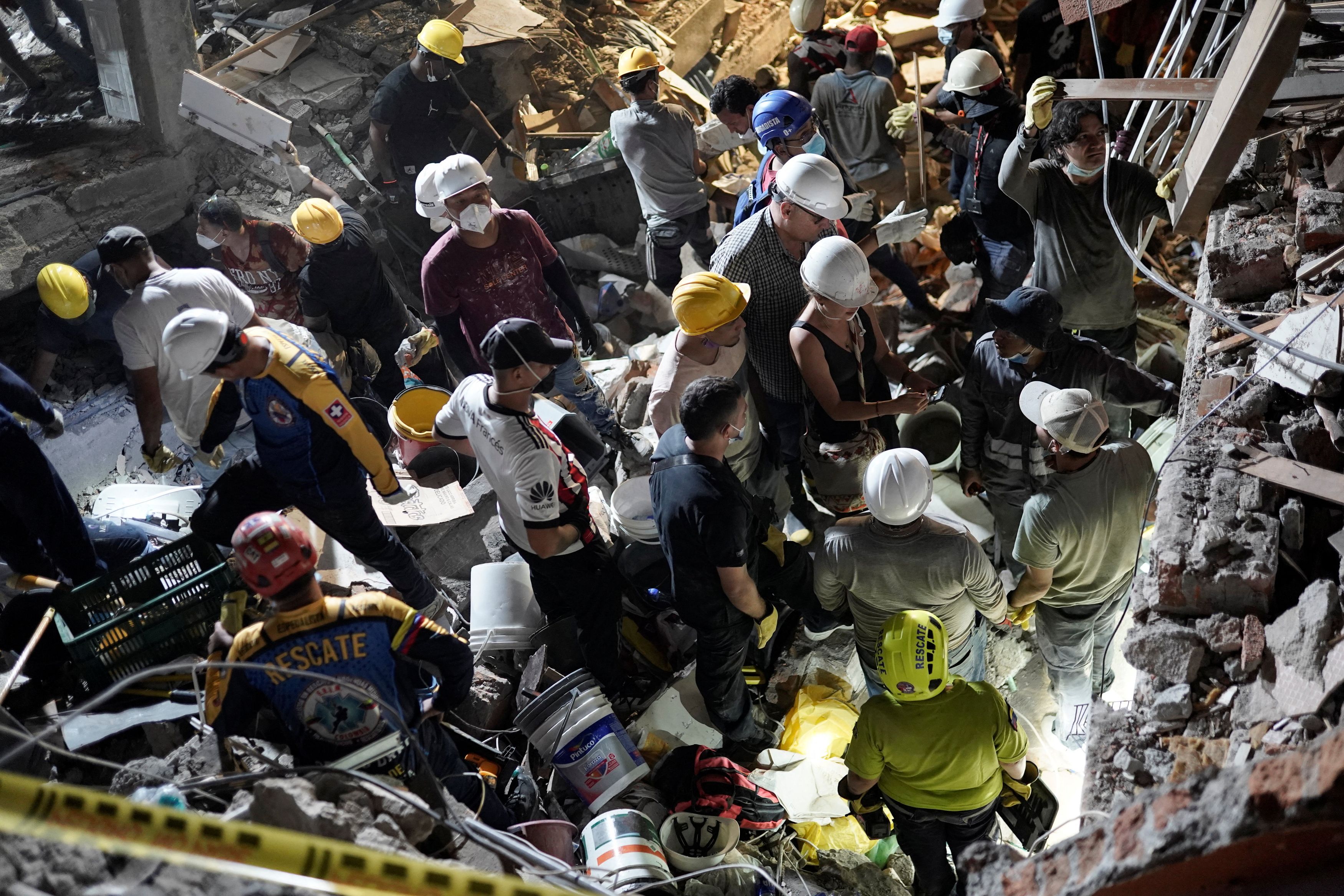 Rescuers work at the site of a collapsed building in Cali, Colombia, on Monday, after the earthquake. (Sergio Acero/Reuters)