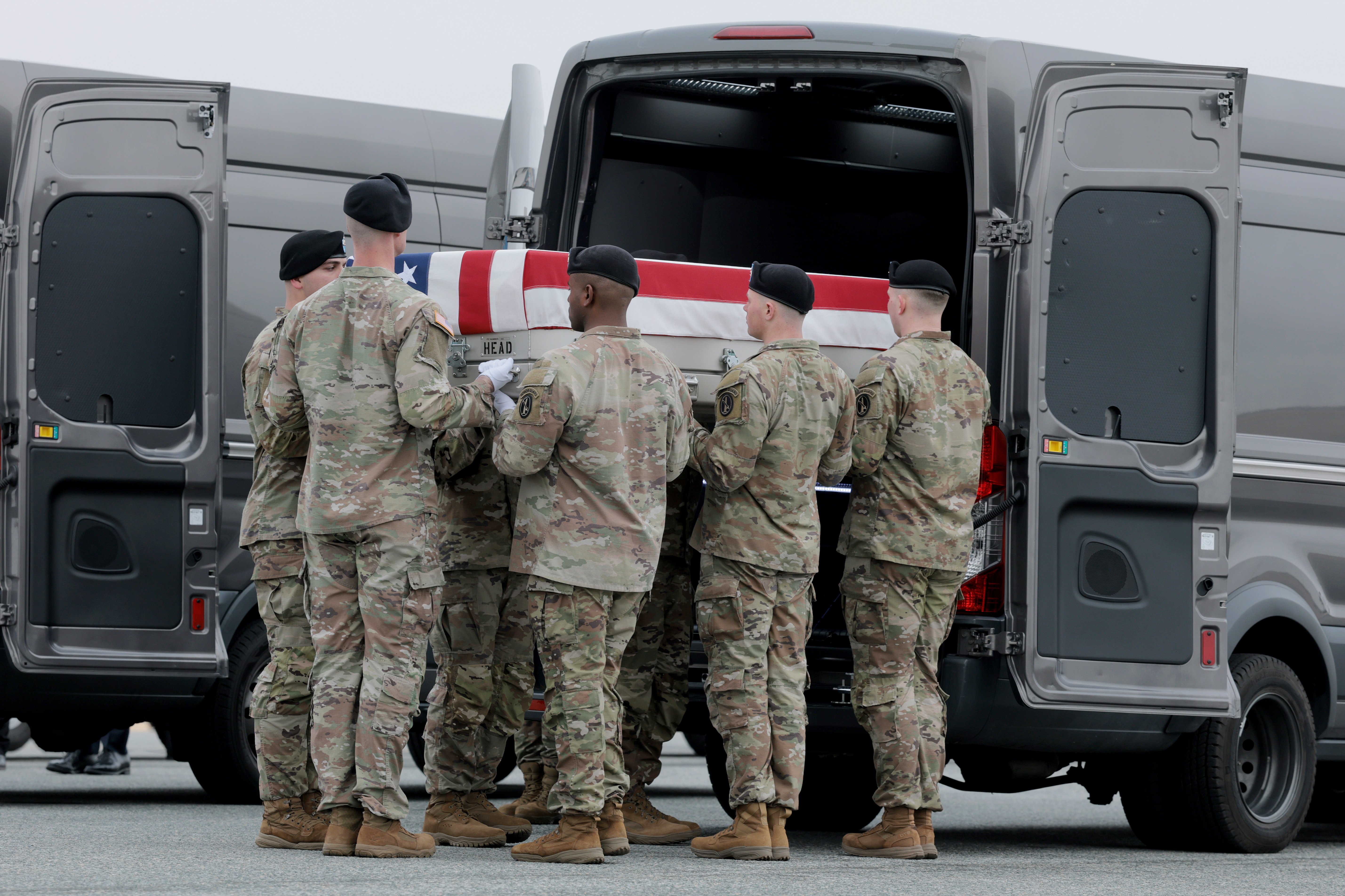 A flag-draped transfer case containing the remains of Maj. Jeffrey R. O’Brien is moved at Dover Air Force Base in Delaware on March 7. (Anna Moneymaker/Getty Images)