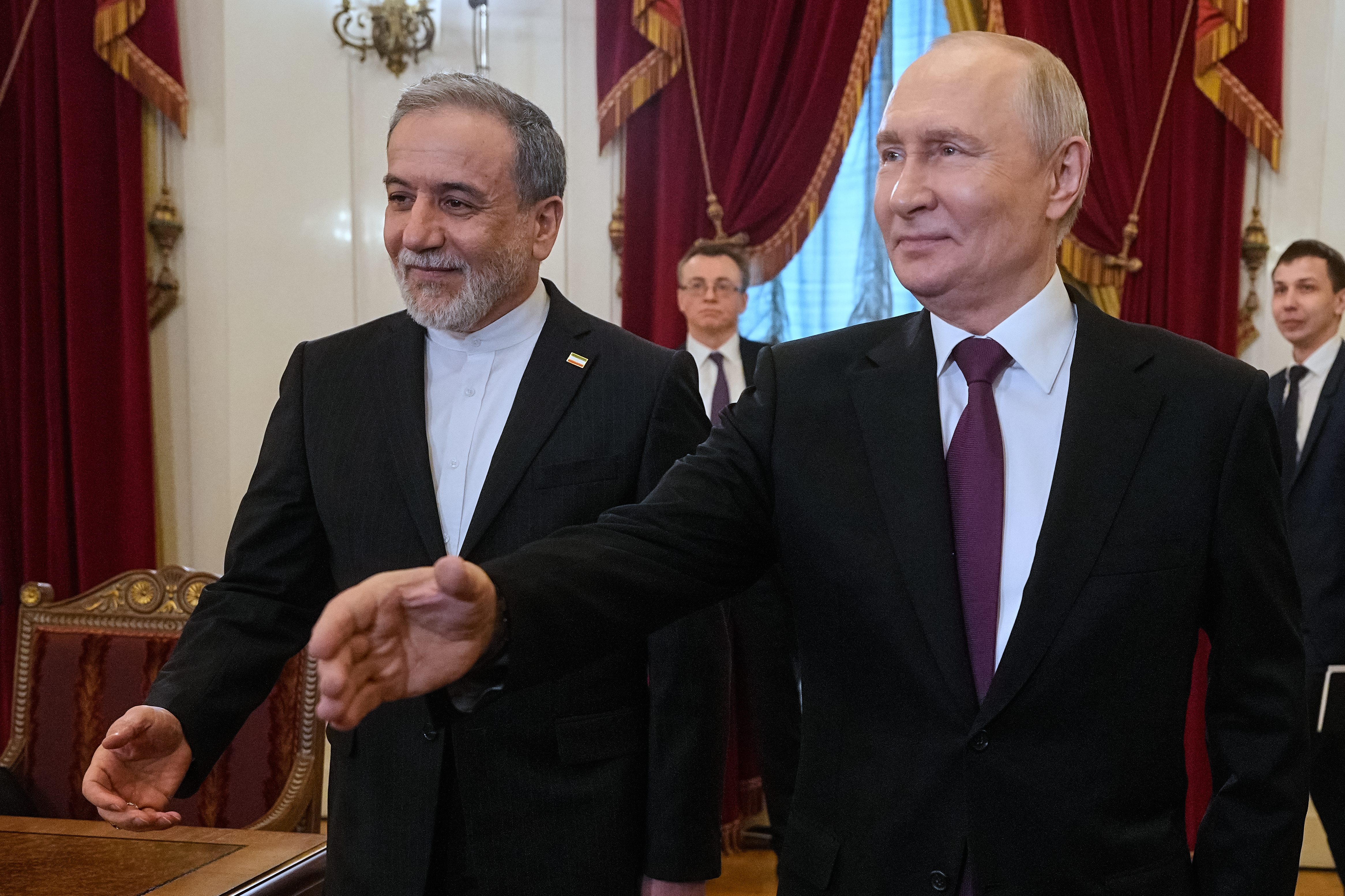 Iranian Foreign Minister Abbas Araghchi, left, and Russian President Vladimir Putin during their meeting Monday in St. Petersburg. (Dmitri Lovetsky/Pool/AP)