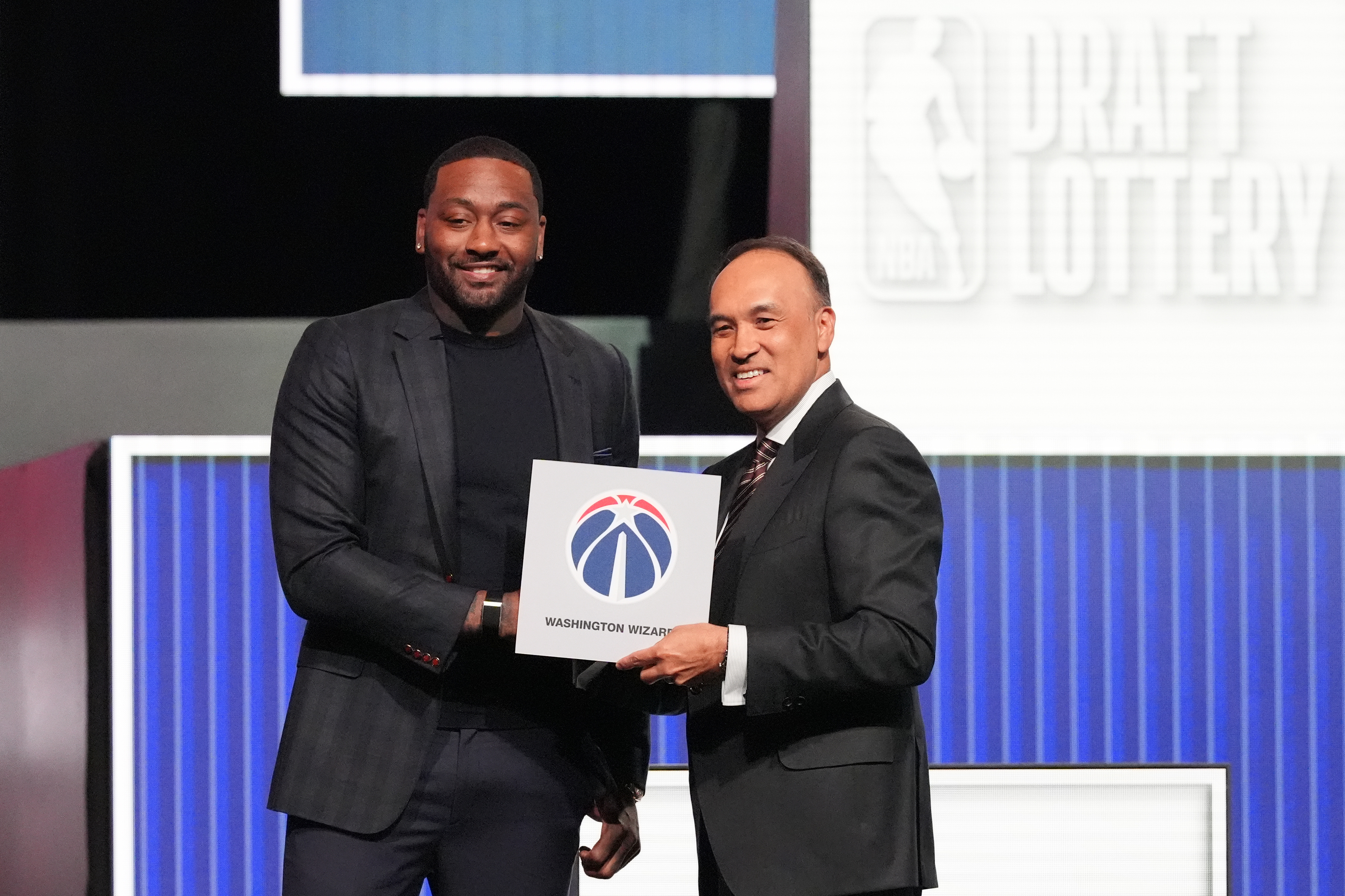 Former Washington Wizards star John Wall, left, and NBA deputy commissioner Mark Tatum, after the Wizards won the draft lottery. (Nam Y. Huh/AP)