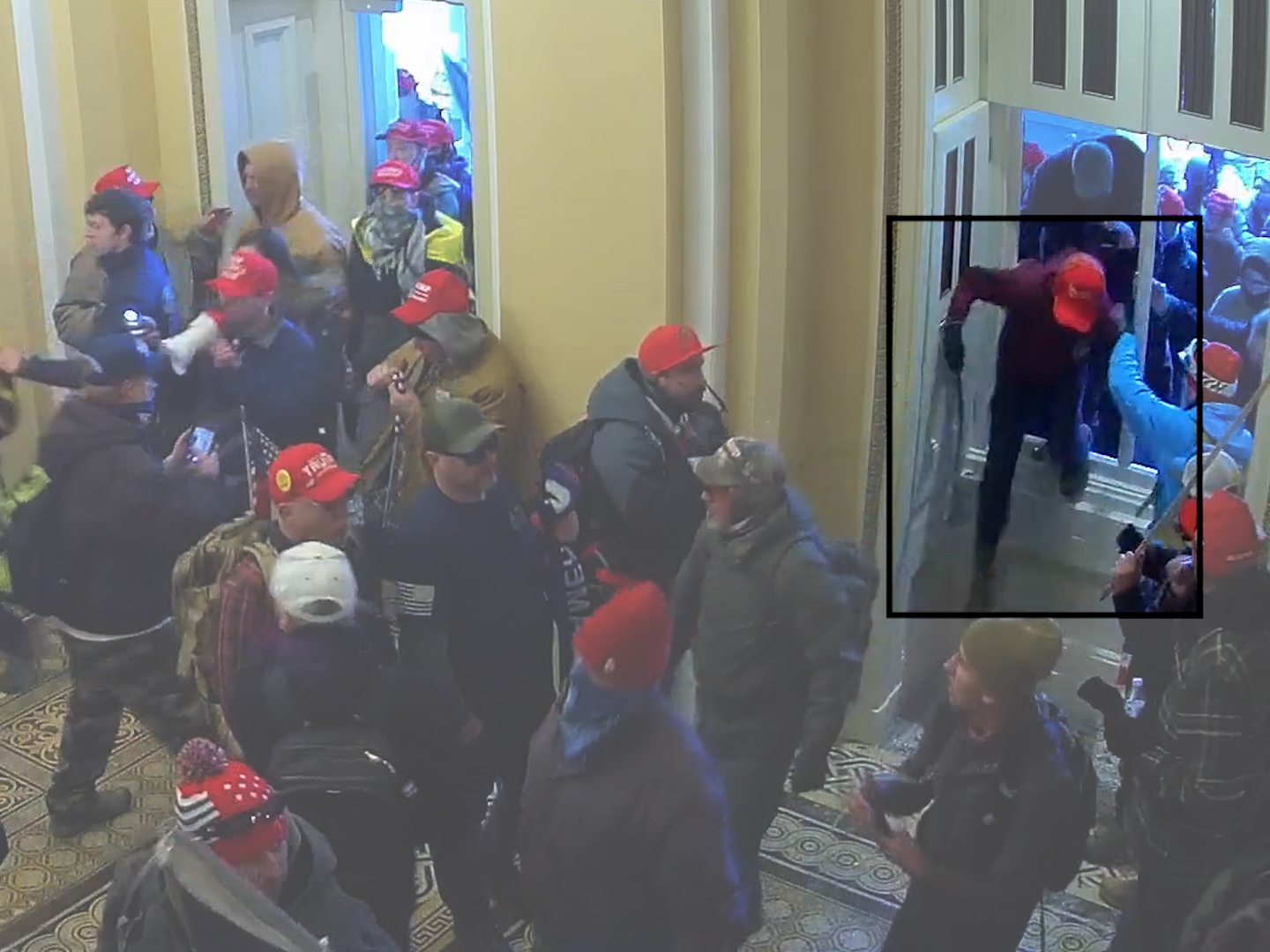A screenshot from a video shows Elias Irizarry crawling through a broken window on the Senate side of the Capitol on Jan. 6, 2021. (Committee on House Administration Subcommittee on Oversight)
