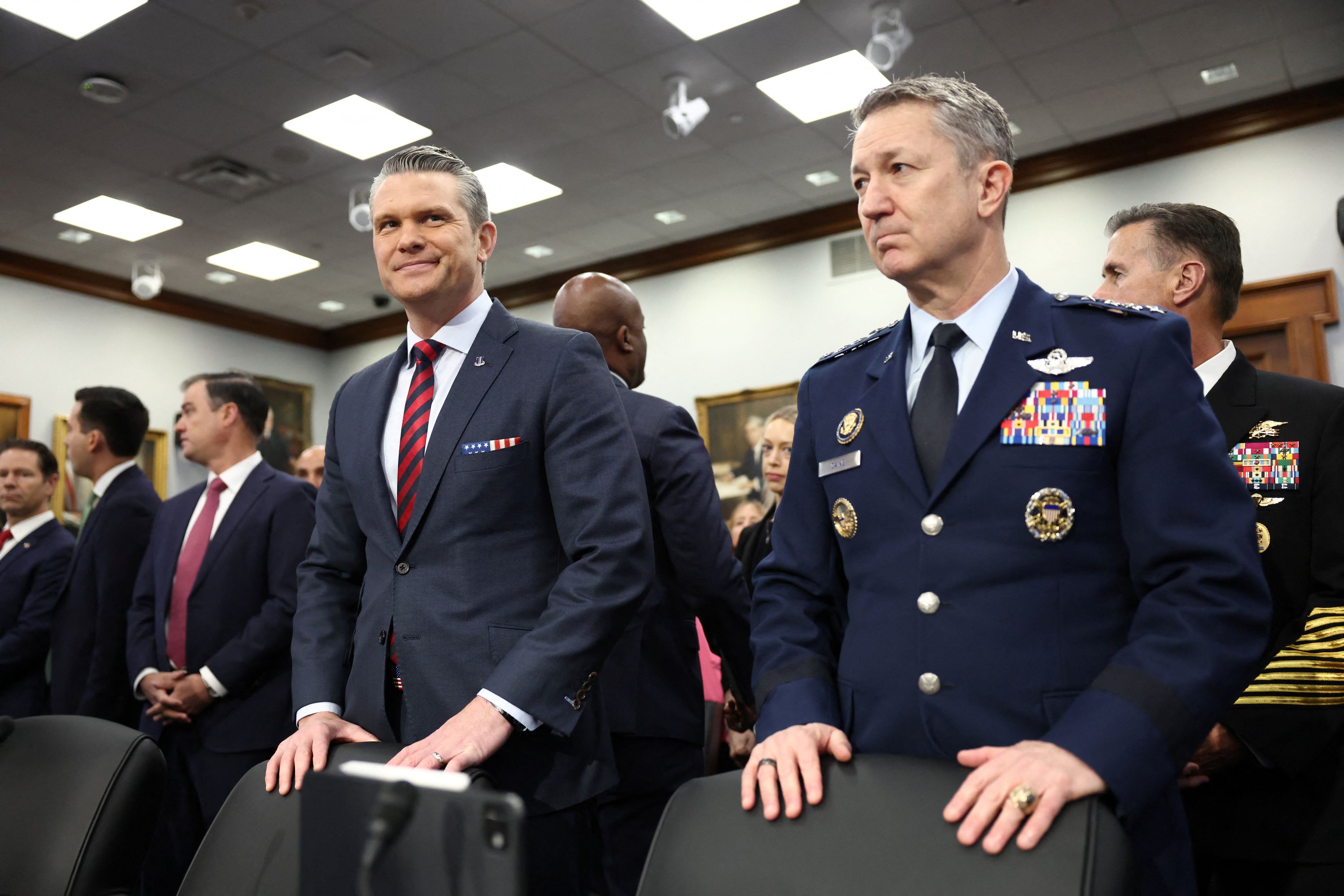 Defense Secretary Pete Hegseth, left, and Gen. Dan Caine, chairman of the Joint Chiefs of Staff, prepare to testify Tuesday before a House subcommittee on Capitol Hill. (Kevin Lamarque/Reuters)