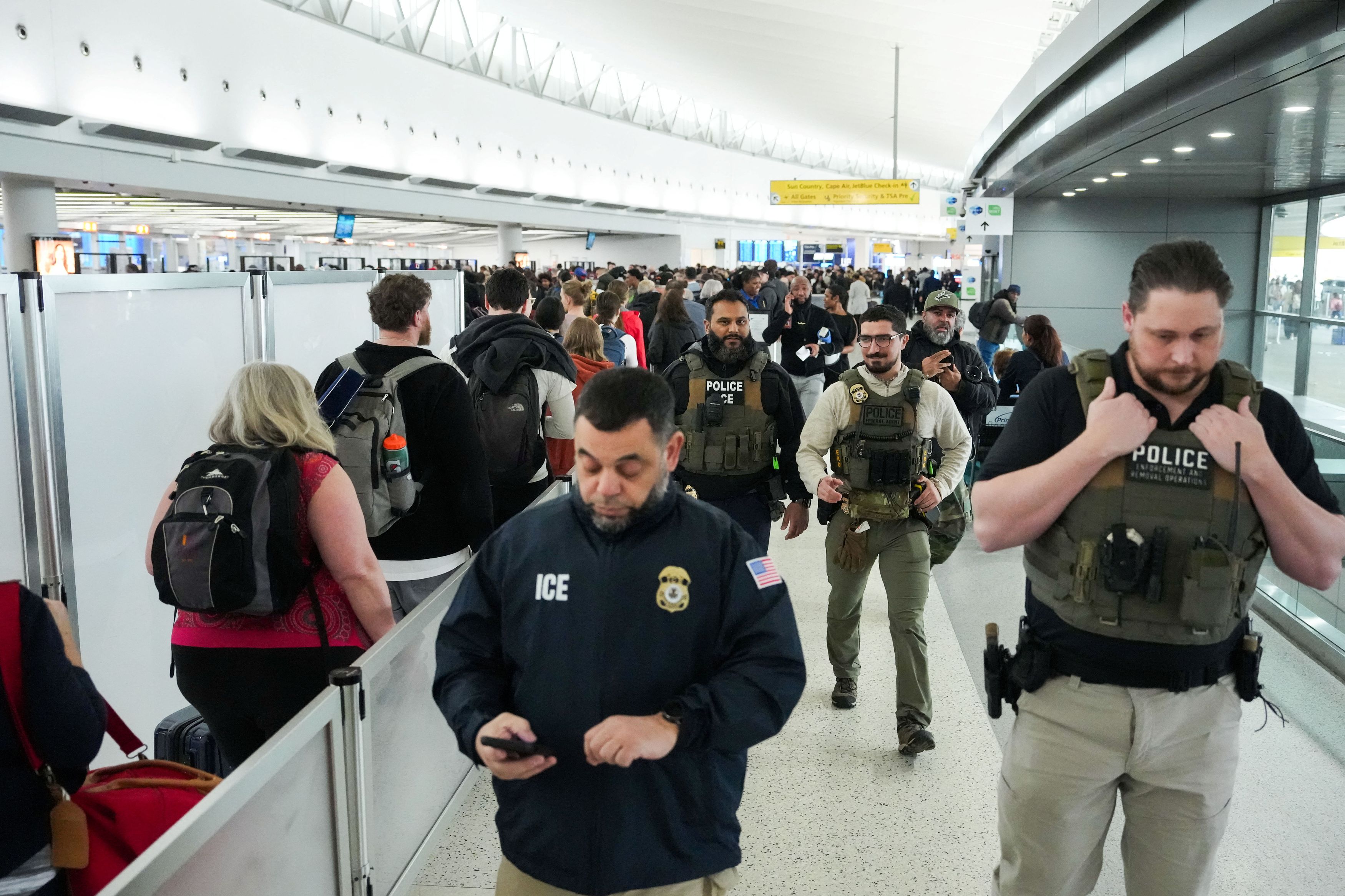 Immigration and Customs Enforcement agents patrol at John F. Kennedy International Airport in New York on Monday. (Adam Gray/Reuters)