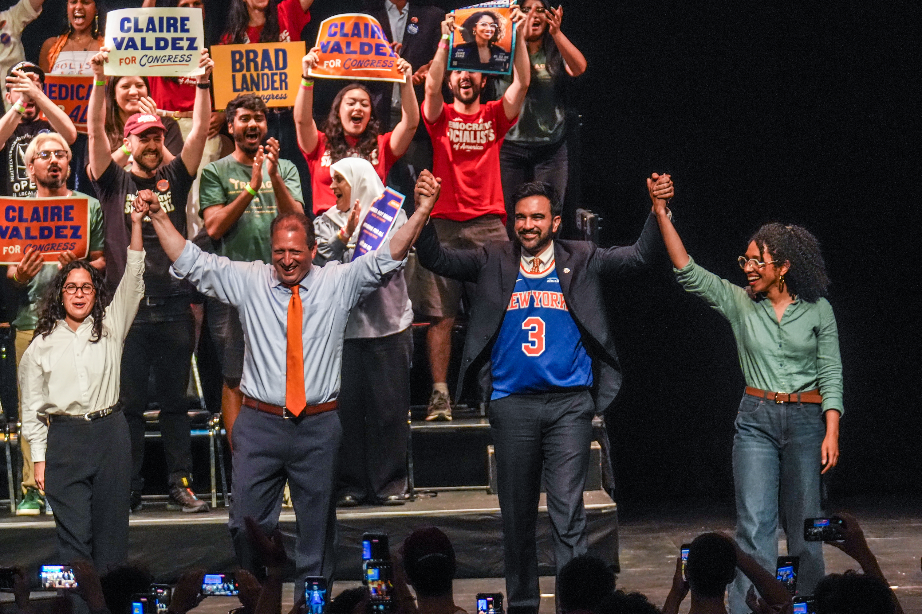 Democratic congressional candidates Claire Valdez, Brad Lander and Darializa Avila Chevalier clasp hands onstage with New York Mayor Zohran Mamdani, second from right, during a rally Thursday in Brooklyn. (Ryan Murphy/AP)