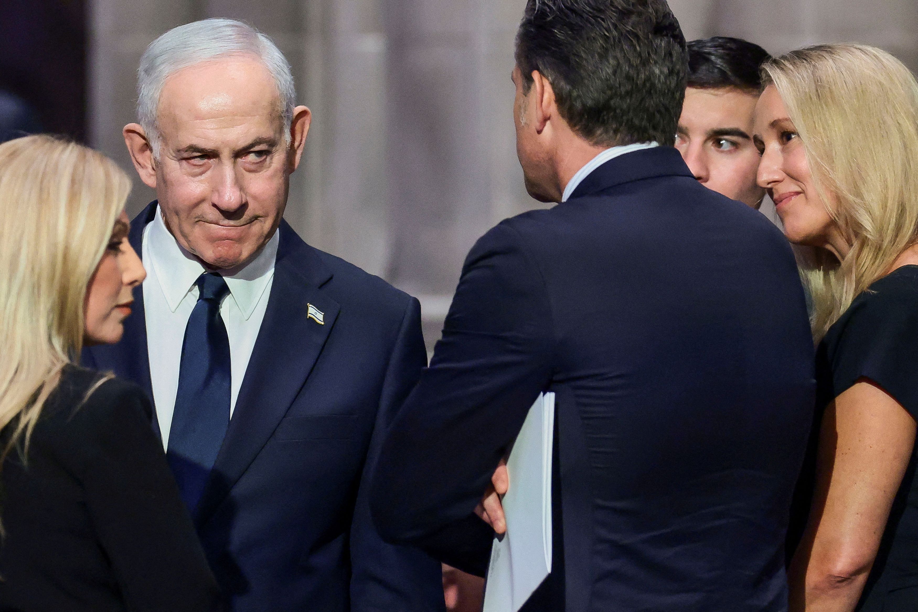 Israeli Prime Minister Benjamin Netanyahu, left, and Defense Secretary Pete Hegseth were among those attending the funeral for Lindsey Graham, the Republican senator from South Carolina. (Evelyn Hockstein/Reuters)