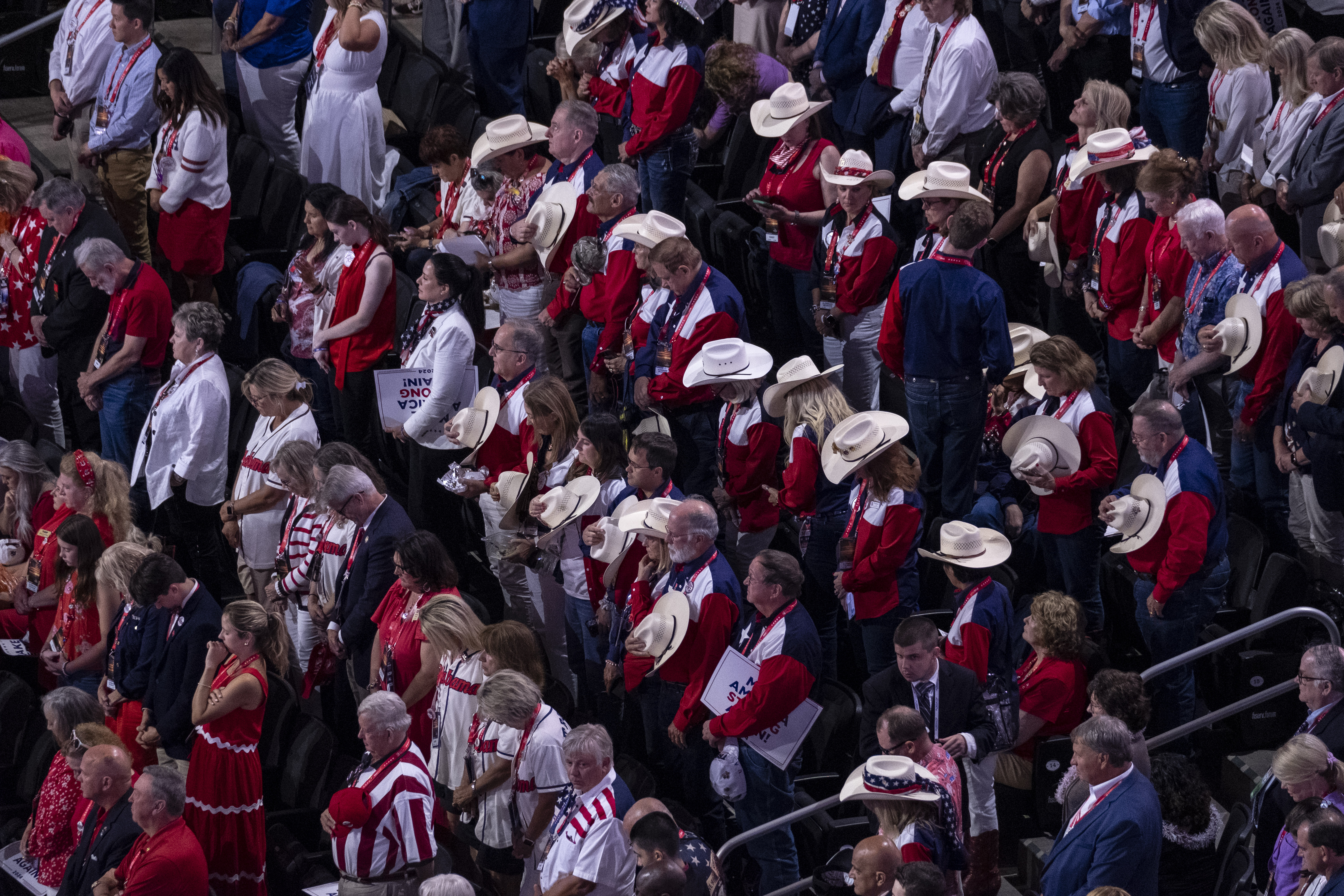 People pray at the Republican National Convention in Milwaukee, Wisconsin, on July 17, 2024. (Joel Angel Juarez/For The Washington Post)