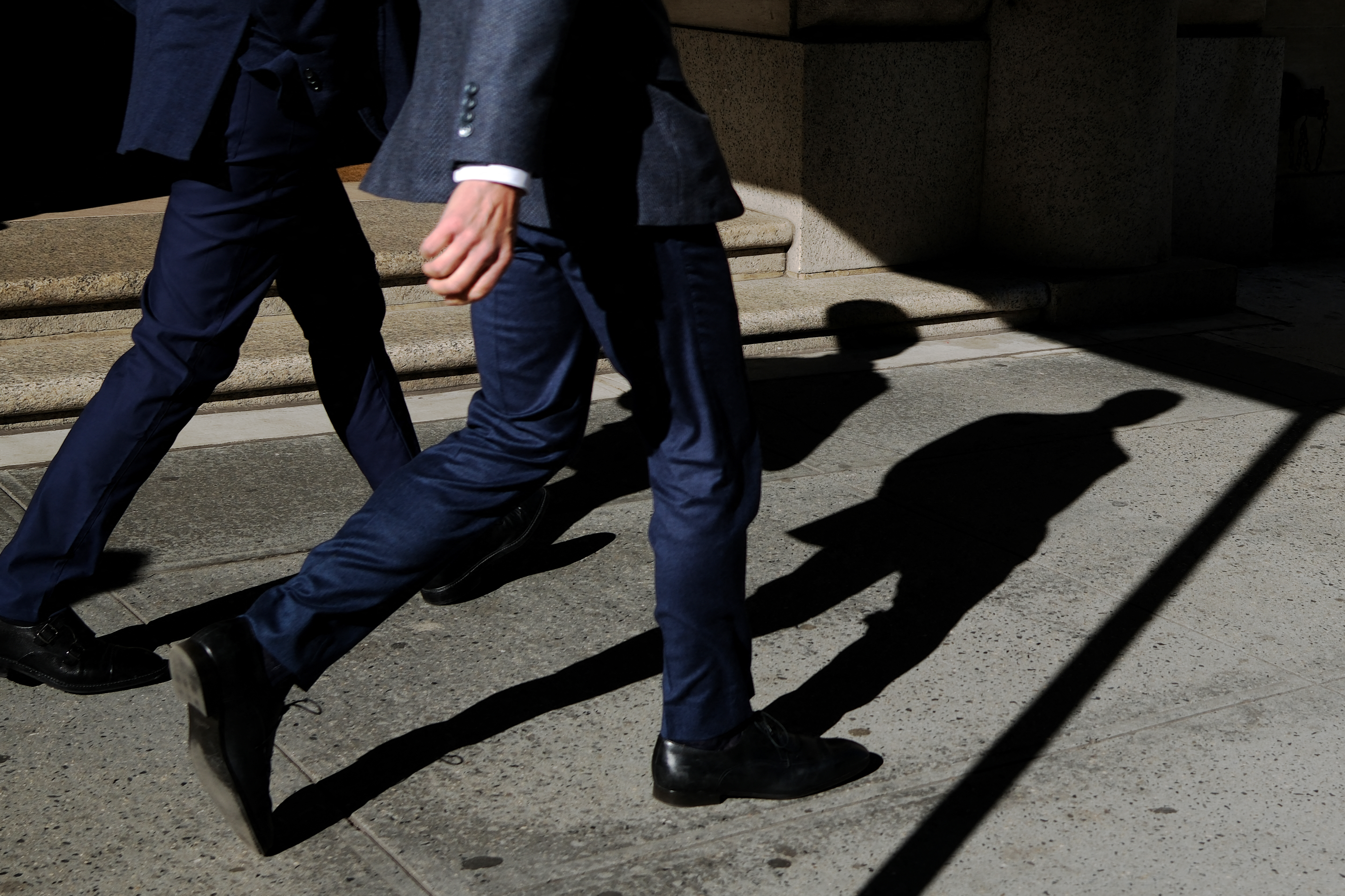 Men walk down a sidewalk in Manhattan in 2024. (Charly Triballeau/AFP/Getty Images)