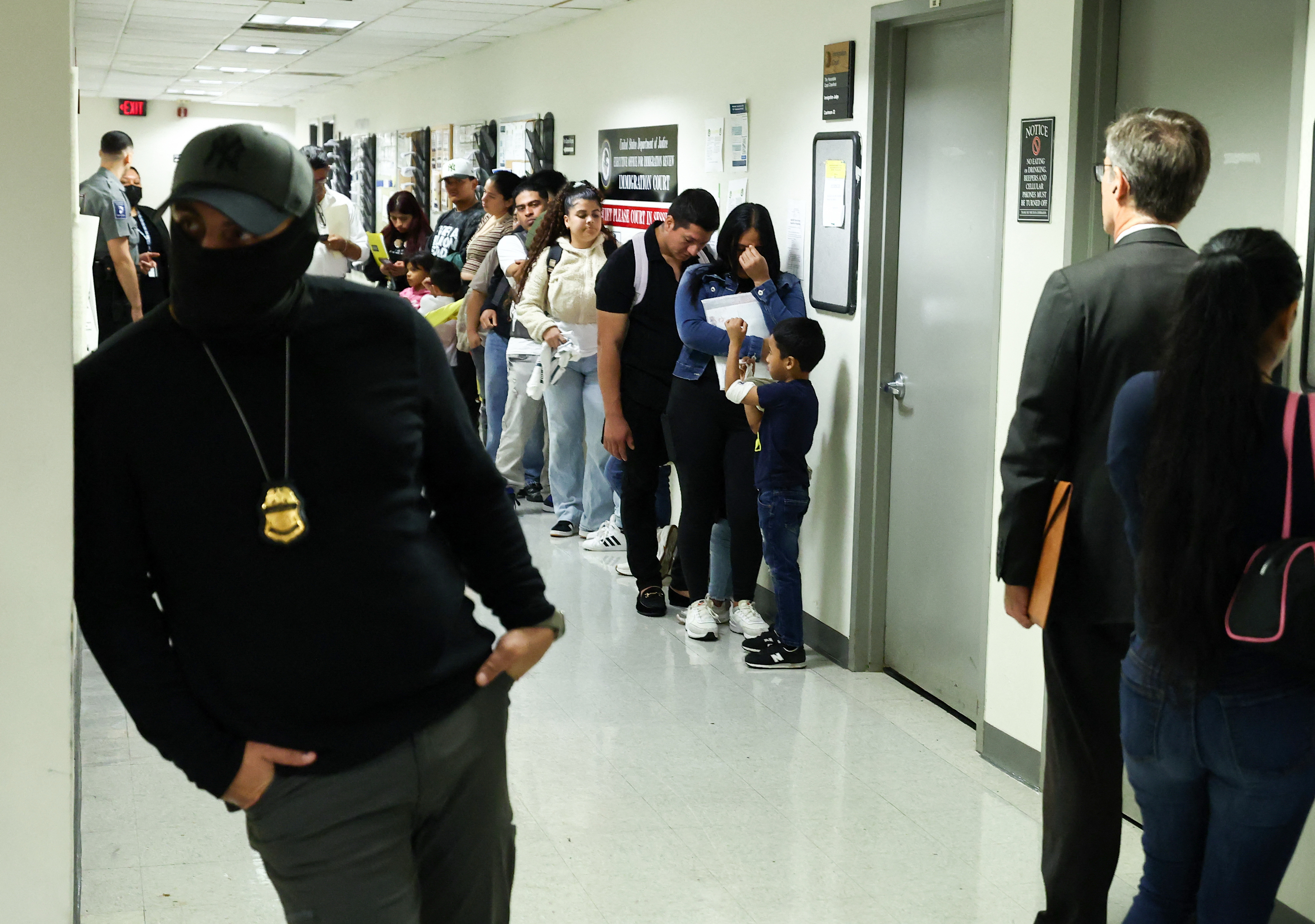 People line up before their hearings at the New York Federal Plaza Immigration Court inside the Jacob K. Javits Federal Building in New York in 2025. (Charly Triballeau/AFP/Getty Images)