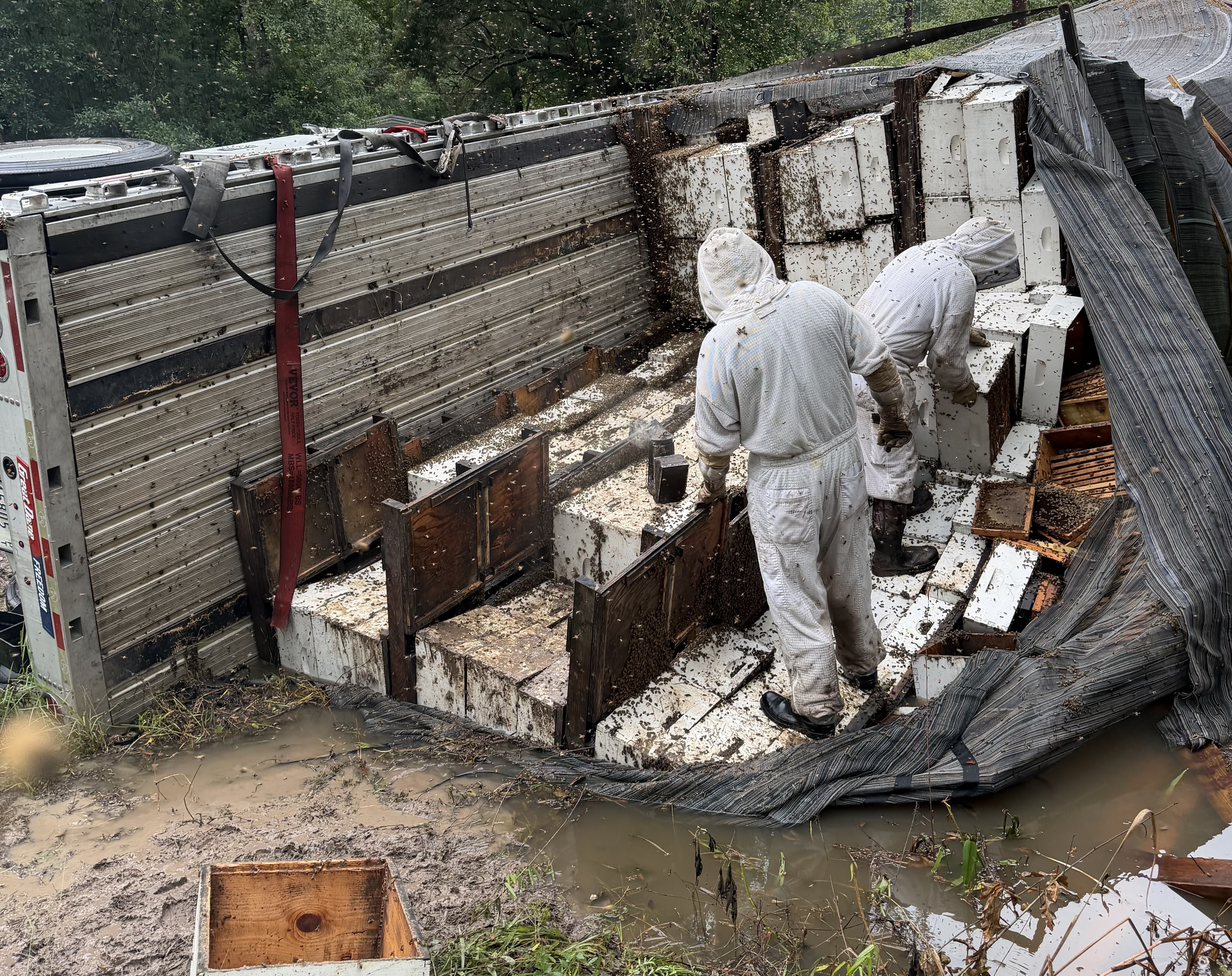 Beekeepers removed hives from an overturned truck. (Christie Ray/Queen Bee Supply)