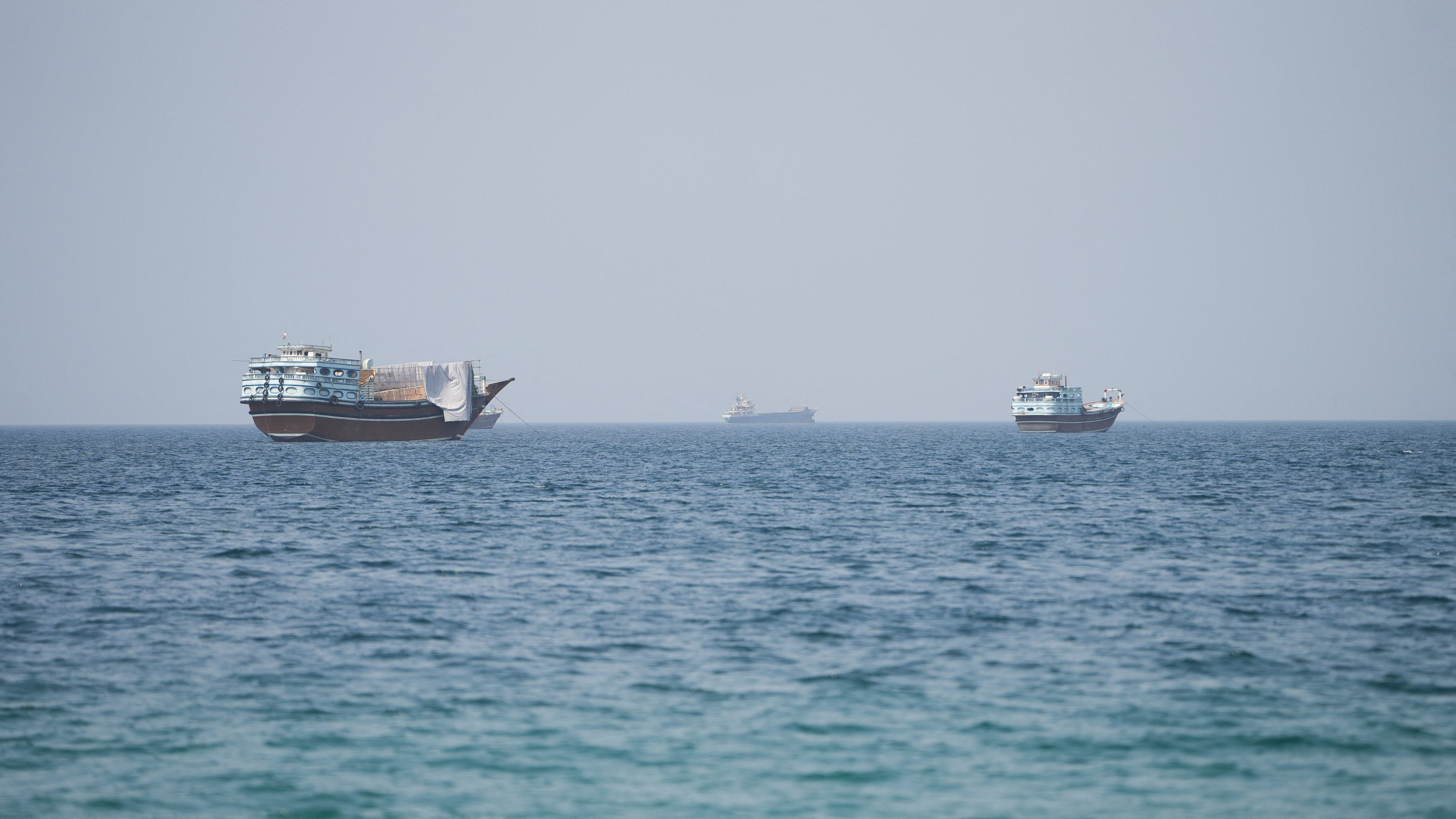 Vessels near the Strait of Hormuz on Thursday, as seen from Oman. (Reuters)