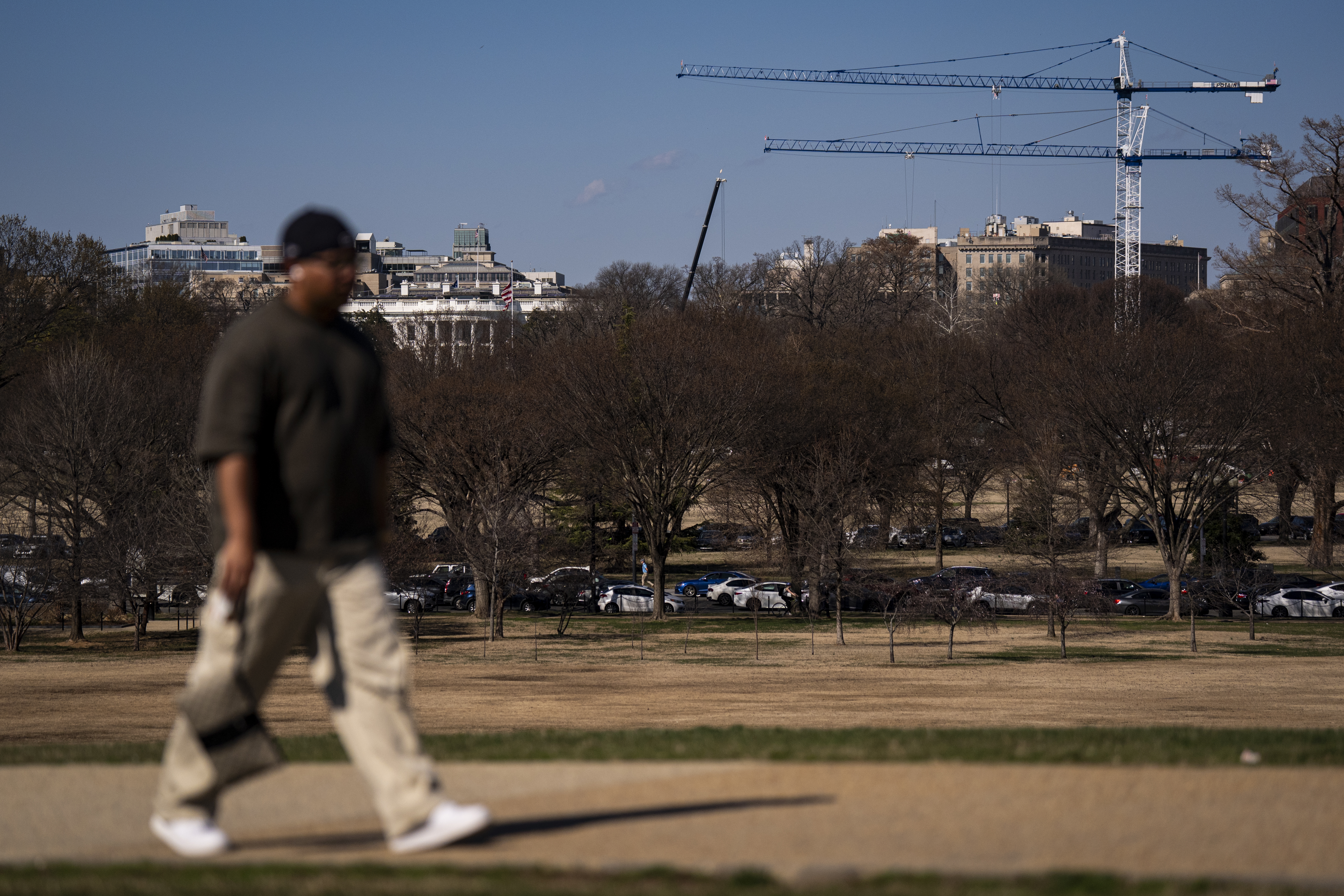 Cranes loom over the White House last month during construction on the new White House ballroom. (Al Drago/For The Washington Post)