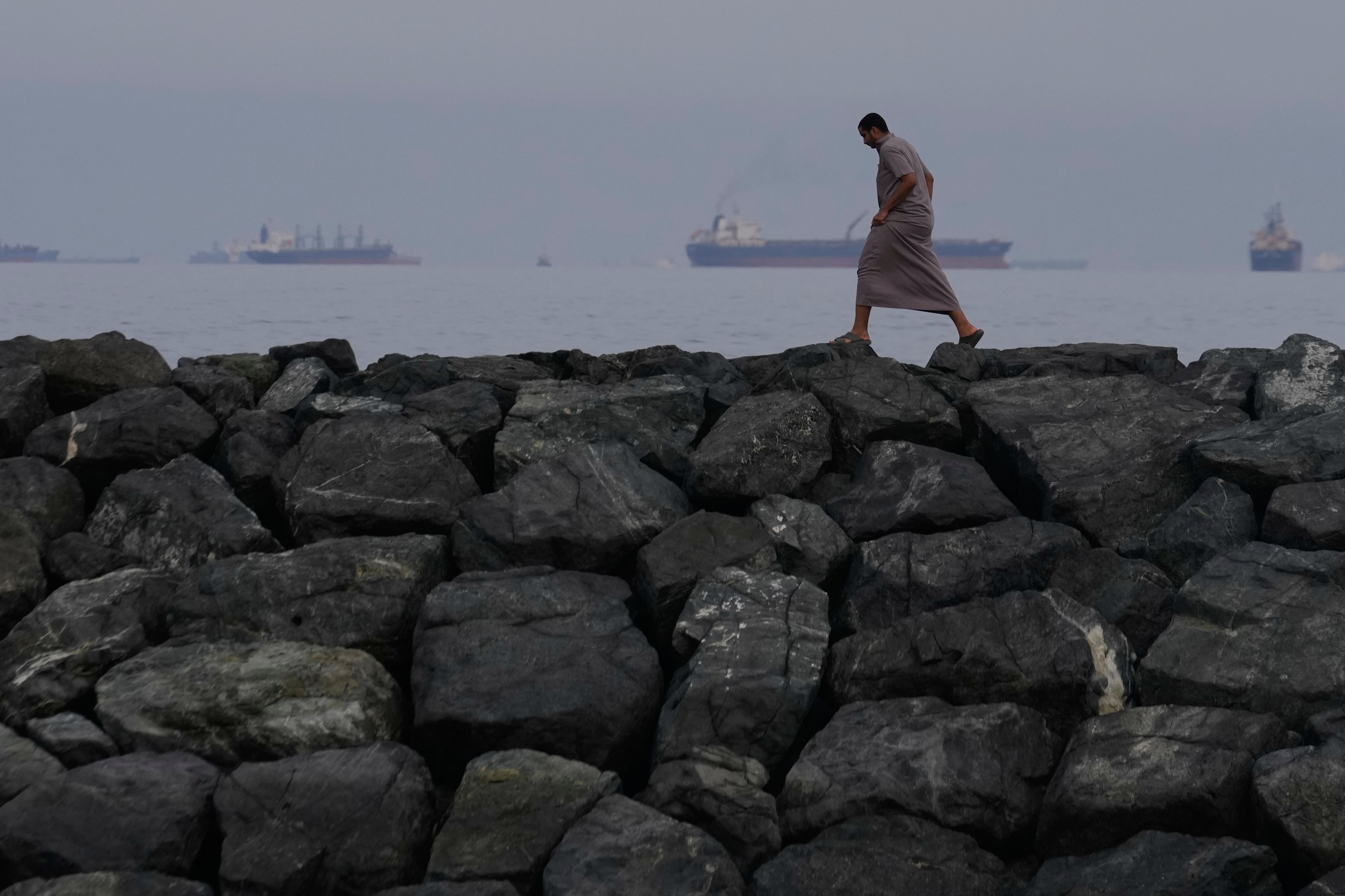 Oil tankers and cargo ships line up last month in the Strait of Hormuz, which Iran has effectively closed. (Altaf Qadri/AP)