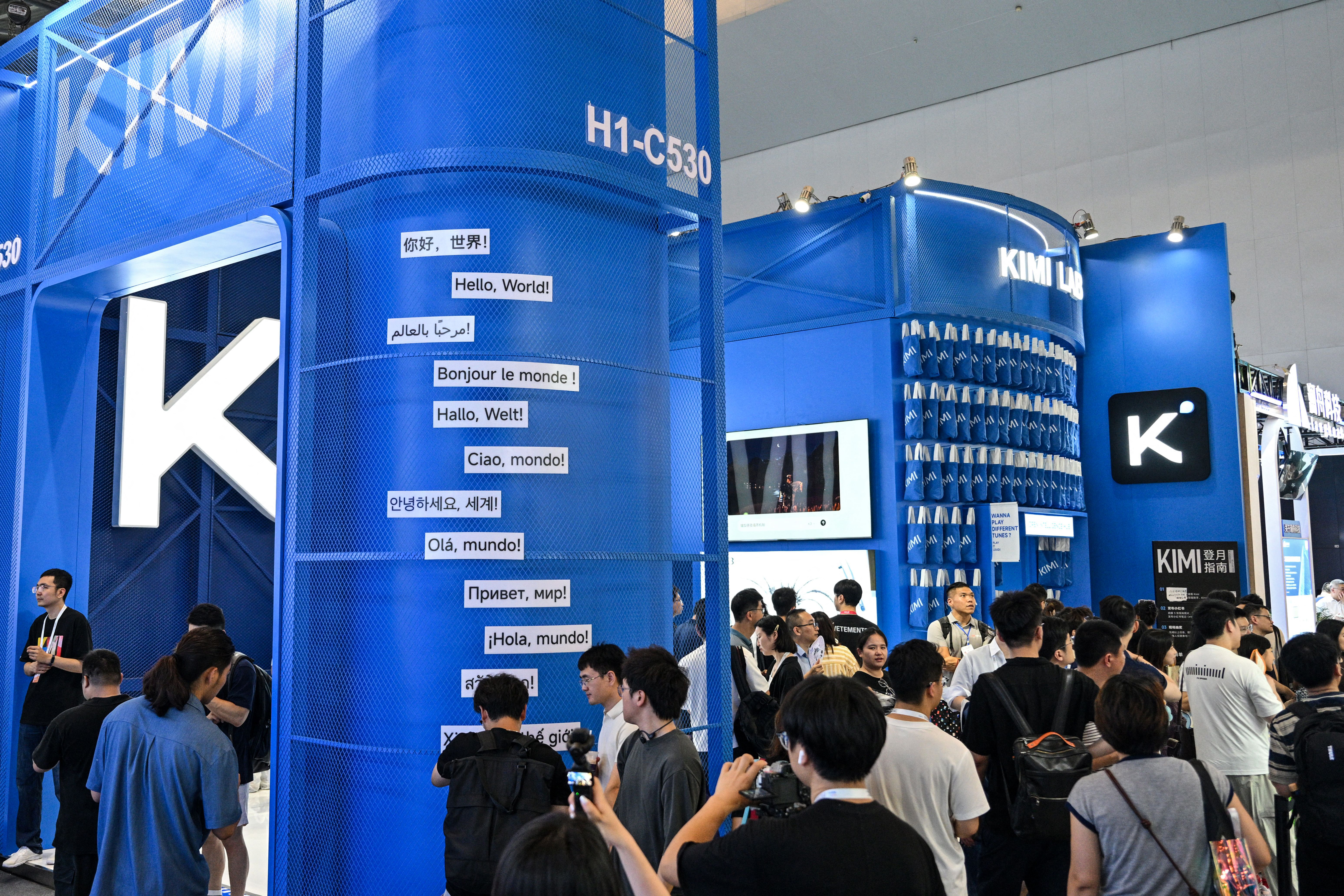 Visitors at the Moonshot AI stand, featuring the Kimi K3 model, during the World Artificial Intelligence Conference in Shanghai on July 18. (Hector Retamal/AFP/Getty Images)
